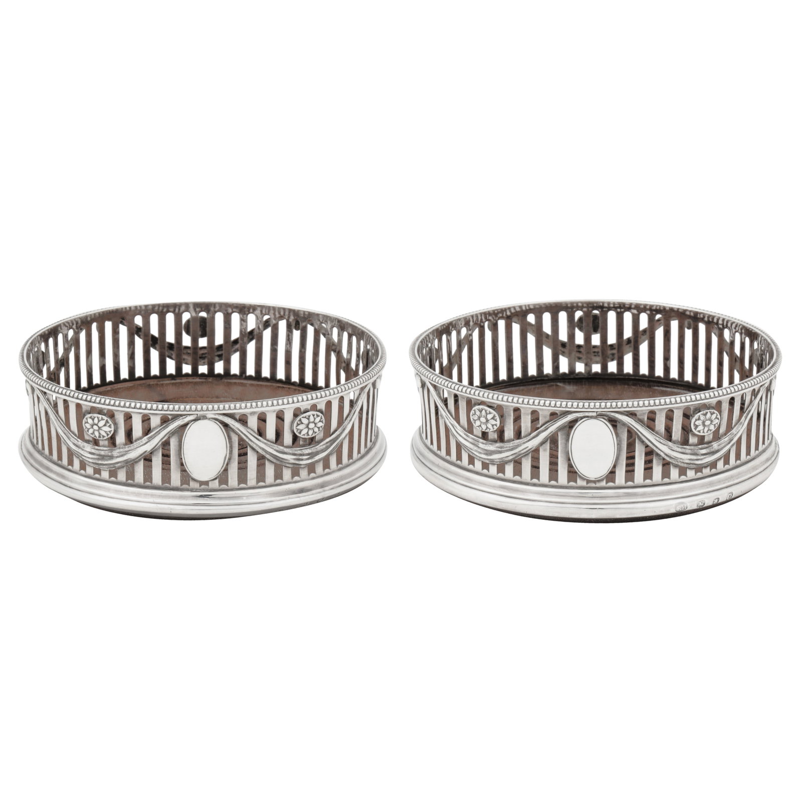 London 1778 by Robert Hennell I (reg. 30th May 1772) A pair of George III sterling silver wine: London 1778 by Robert Hennell I (reg. 30th May 1772) A pair of George III sterling silver wine coasters Each of circular form with a beaded rim, pierced slat sides with embossed and applied lambrequin