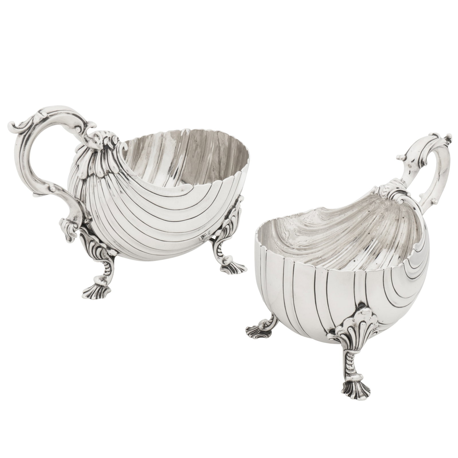 London 1760 by Edward Wakelin and London 1801 by William Frisbee A matched pair of George III: London 1760 by Edward Wakelin and London 1801 by William Frisbee A matched pair of George III sterling silver sauce boats Each modelled as a scallop shell form with scalloped rims and scroll capped S-