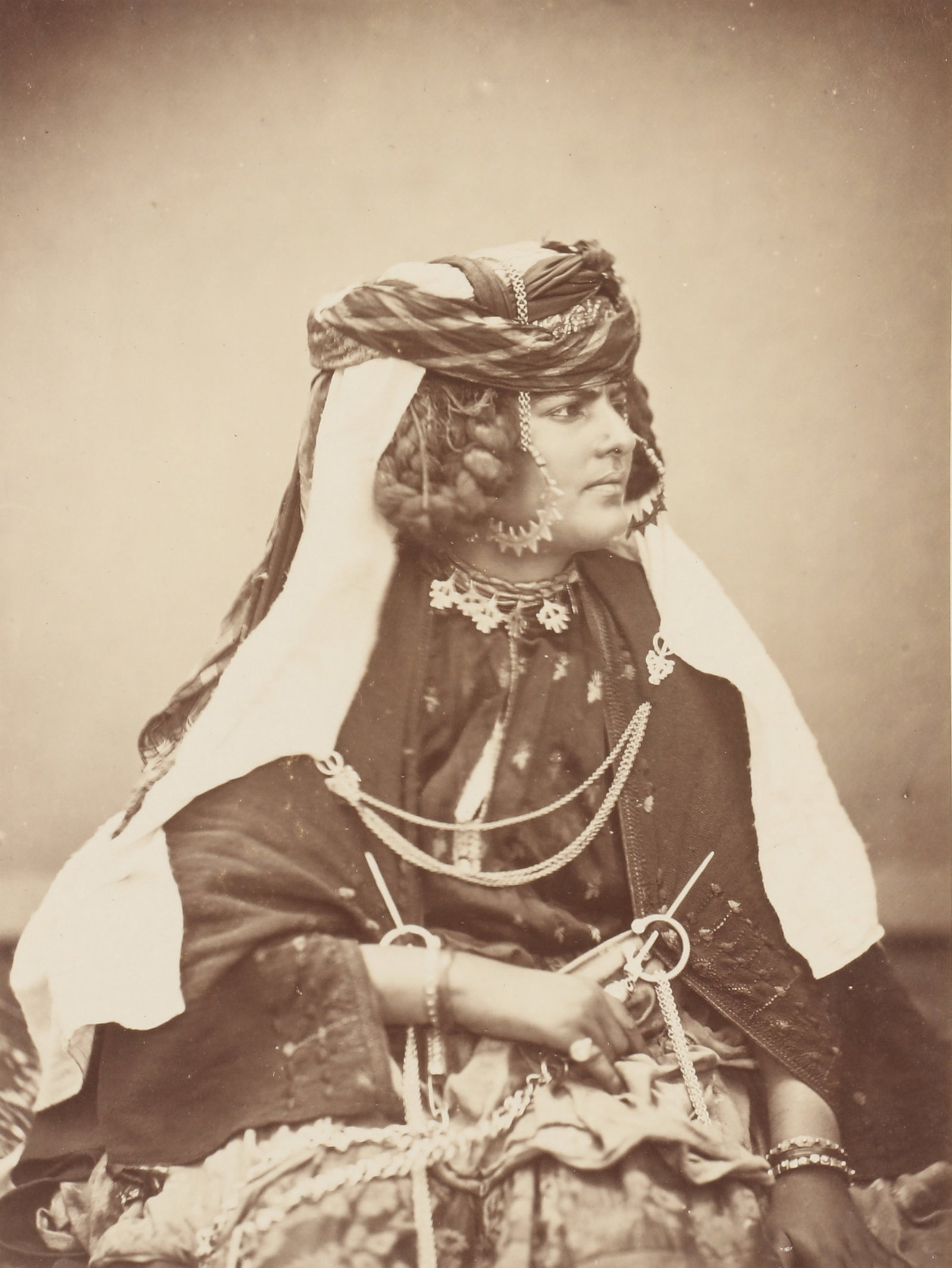 Claude-Joseph Portier (1841-1910) (attr.) Algerian Female Portraits, c.1875-1885: A group of 4 albumen prints, image size 13 x21cm (smallest) to 22.5 x16.7cm (largest), portraiting Oulad-Nail Women, wearing traditional clothing and heavy silver jewellery; 3 pasted down onto album p