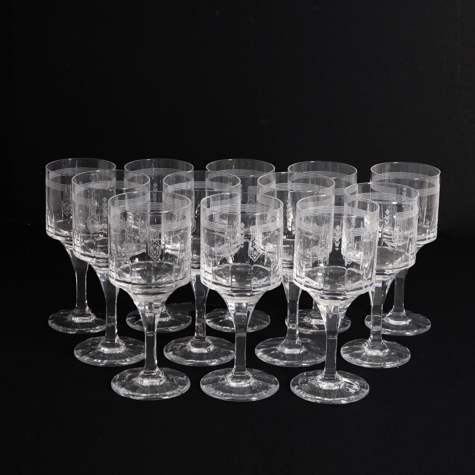 Cartier, France Suite of Cartier drinking glasses: 1965 Cut lead crystal, the body with engraved art nouveau decor Each glass with etched 'Cartier' signature With original Cartier boxes