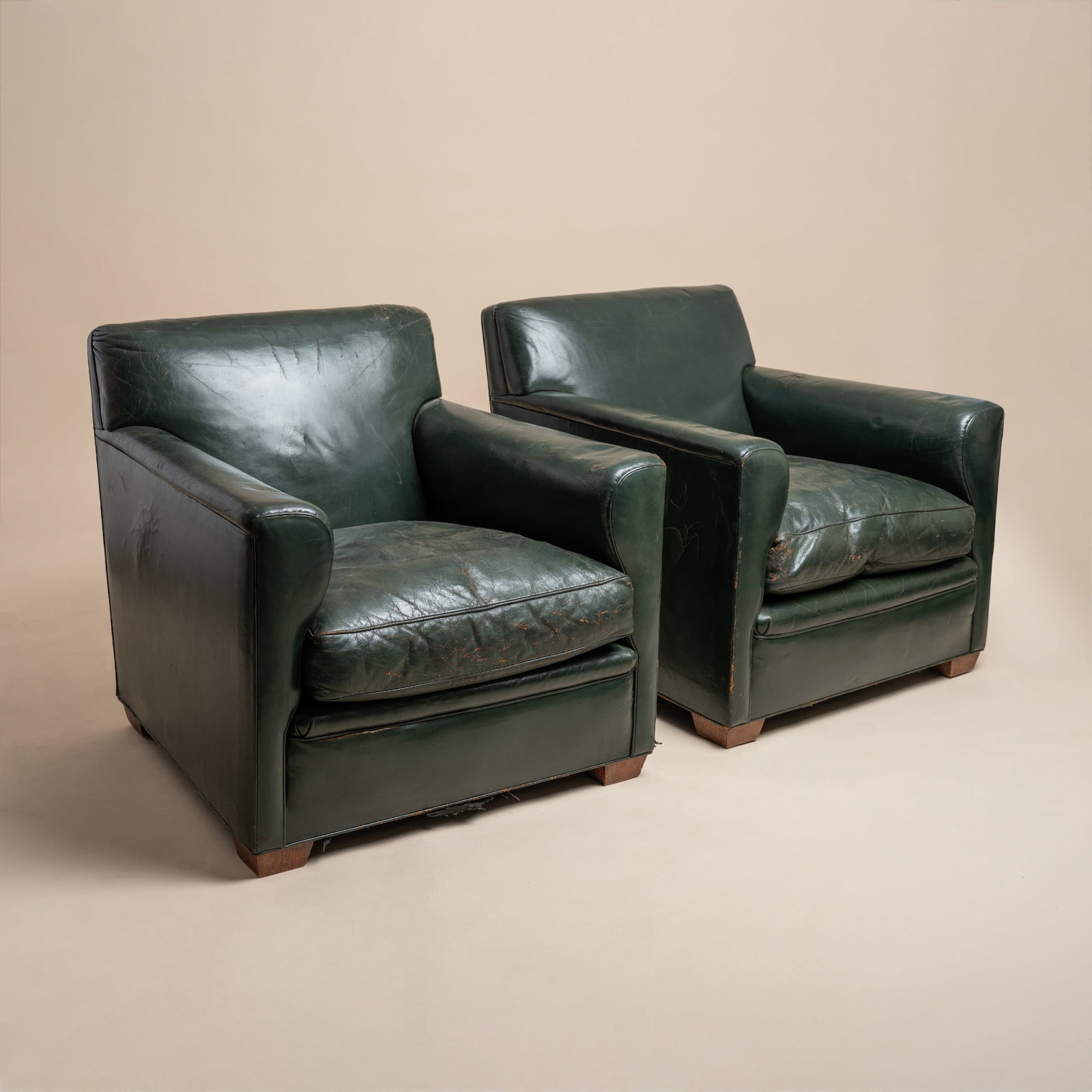 COMTE, Argentina A pair of Club Armchairs, produced for the Presidential Military Club Los Olivos,: Circa 1937 Oak, green leather upholstery 74cm high x 71cm wide x 78cm deep Literature Page 194, 'Jean-Michel Frank - Une aventure Sud-americaine' by Mo Amelia Teitelbaum. Editions AAM, Paris. 2025 Pro