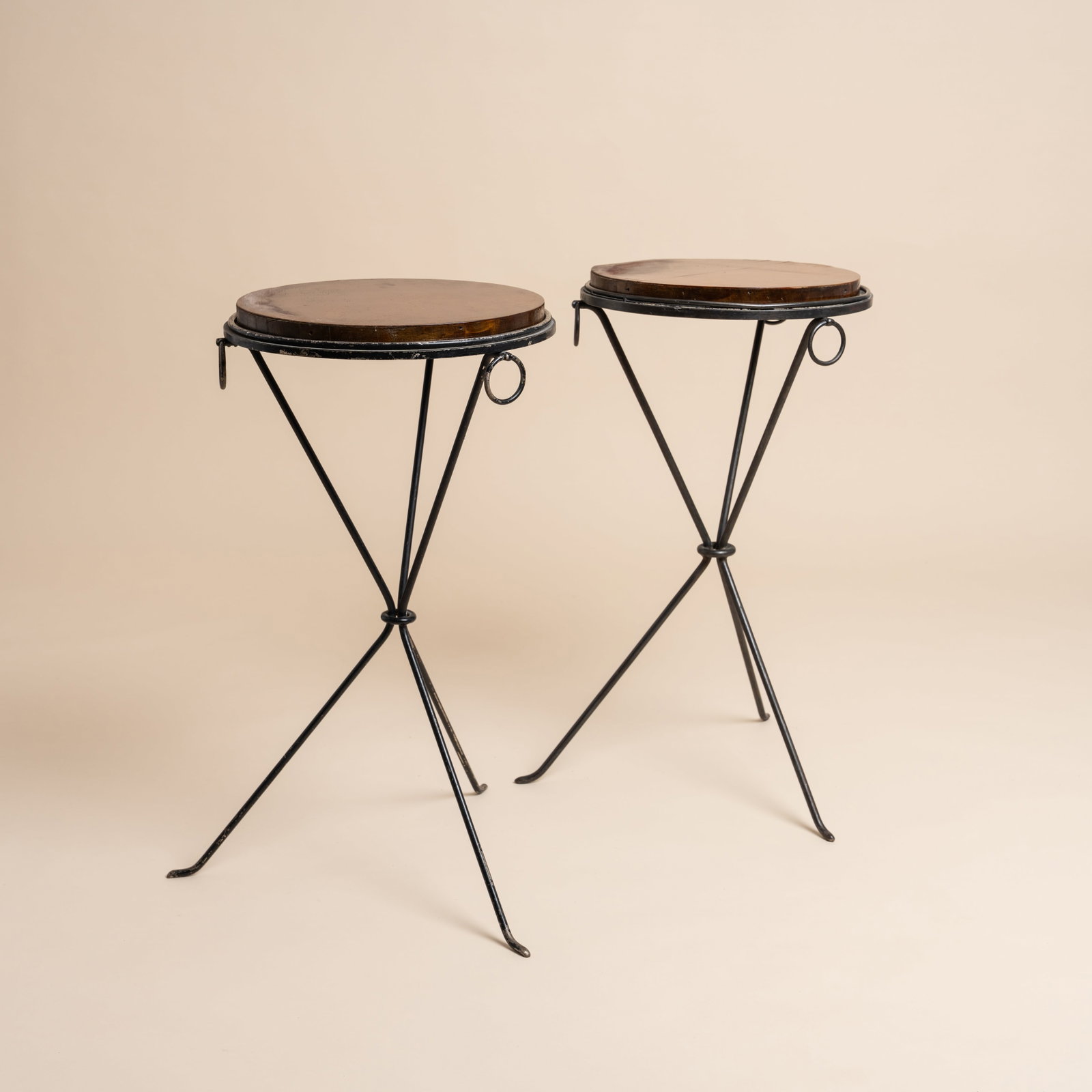 COMTE, to a Jean-Michel Frank design Pair of gueridons: 1936 Painted iron 68cm high x 38cm diameter Literature Page 280, Jean-Michel Frank- Une Aventure Sud-americaine by Mo Amelia Teitelbaum. Editions AAM. Paris. 2025. Provenance: The collection of Mo Ame