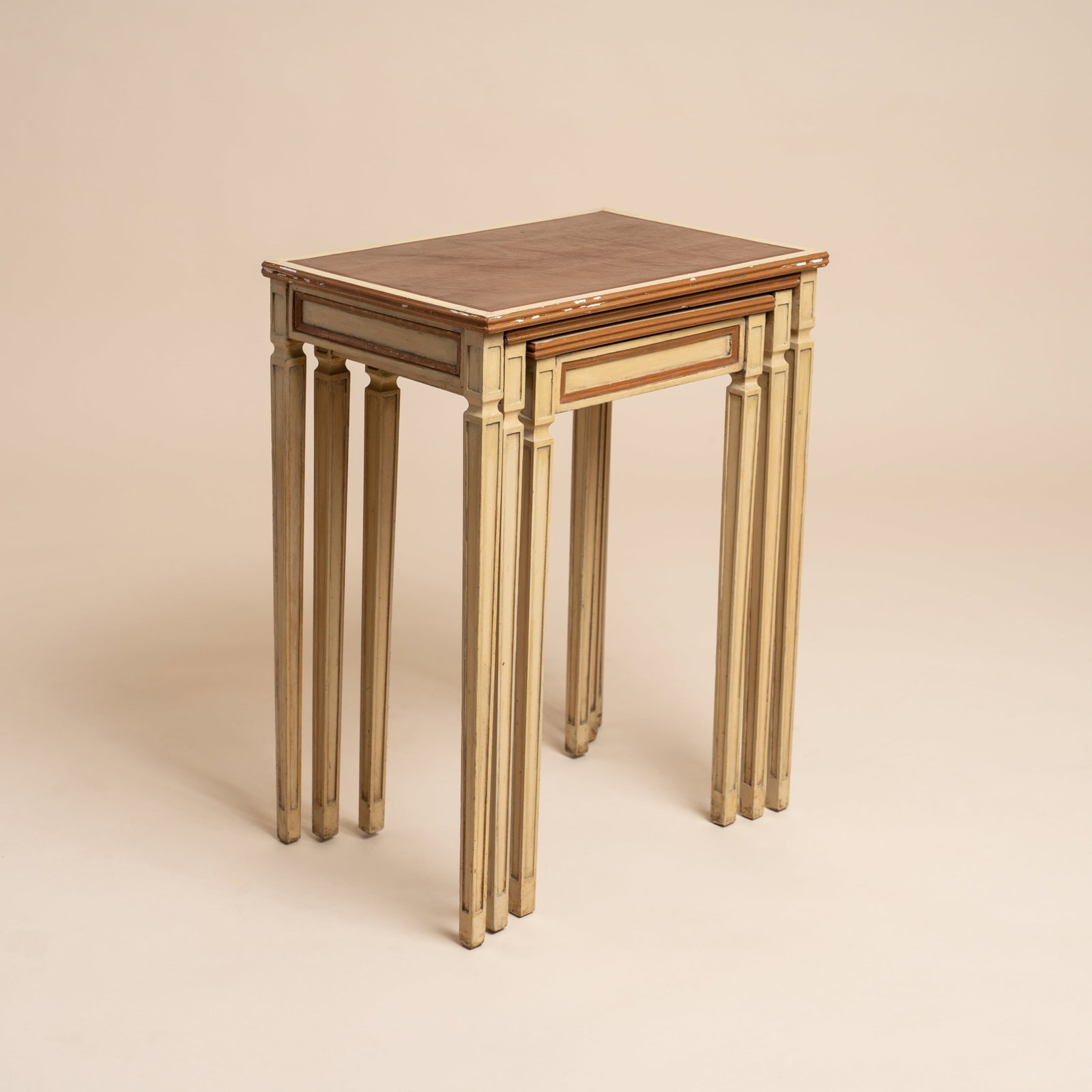 COMTE, to a Jean-Michel Frank design Nest of tables: 1936 Painted oak and leather 61cm high x 50cm wide x 34cm deep Literature Pages 103-107, 'Jean-Michel Frank - Une aventure Sud-americaine' by Mo Amelia Teitelbaum. Editions AAM, Paris. 2025 Provenance
