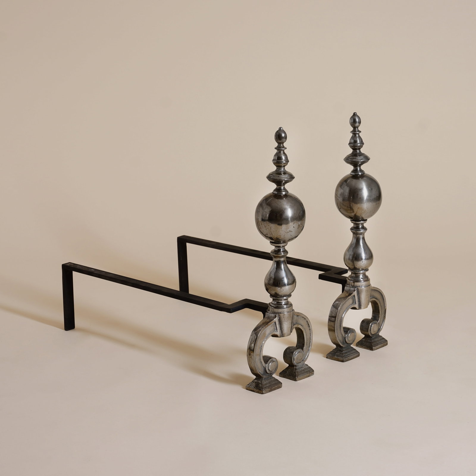 Arts and Crafts Style Pair of Fire Dogs: 20th Century Polished steel, iron 55cm high x 60cm long Provenance: From a Distinguished Private International Collection