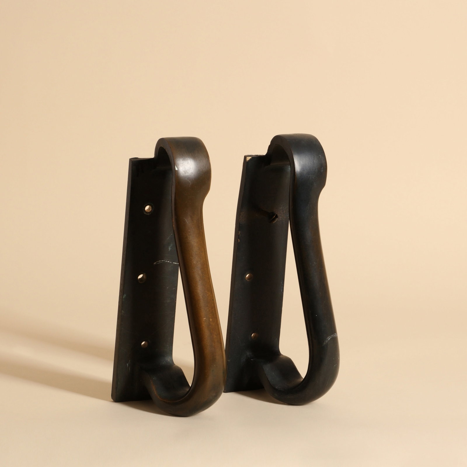 Alvar Alto (Finnish 1898-1976) for Valaistustyo A pair of door handles: Finland, 1950s Patinared bronze Stamped Valaistustyo 25cm long Provenance: From a Distinguished Private International Collection Bukowski, November 2020