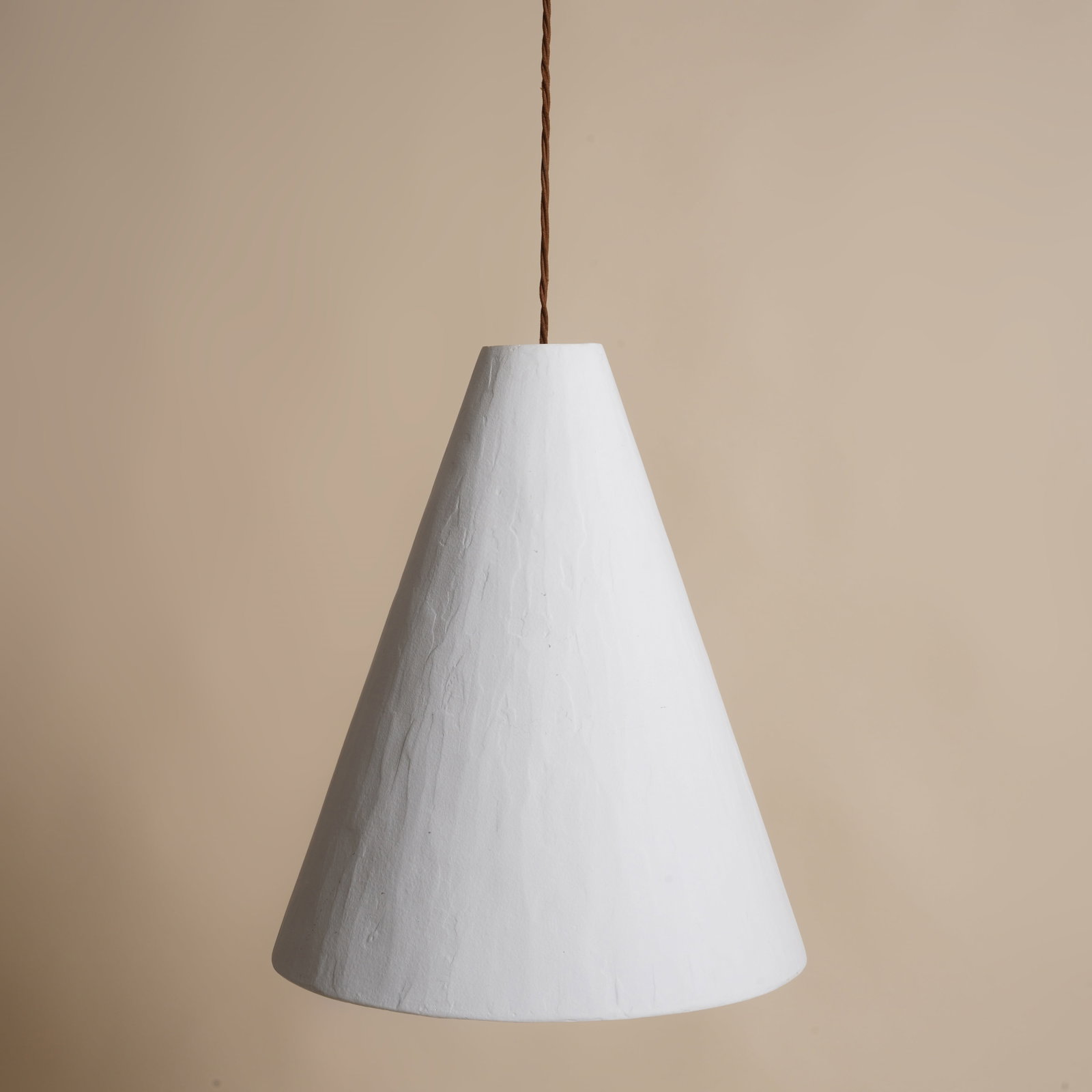 Rose Uniacke, London A Conical Pendant Light: Contemporary Fibreglass, plaster, patinated metal Shade height 49.5cm (total height 150cm) x 41cm diameter Provenance: From a Distinguished Private International Collection Purchased from Fran Hickman