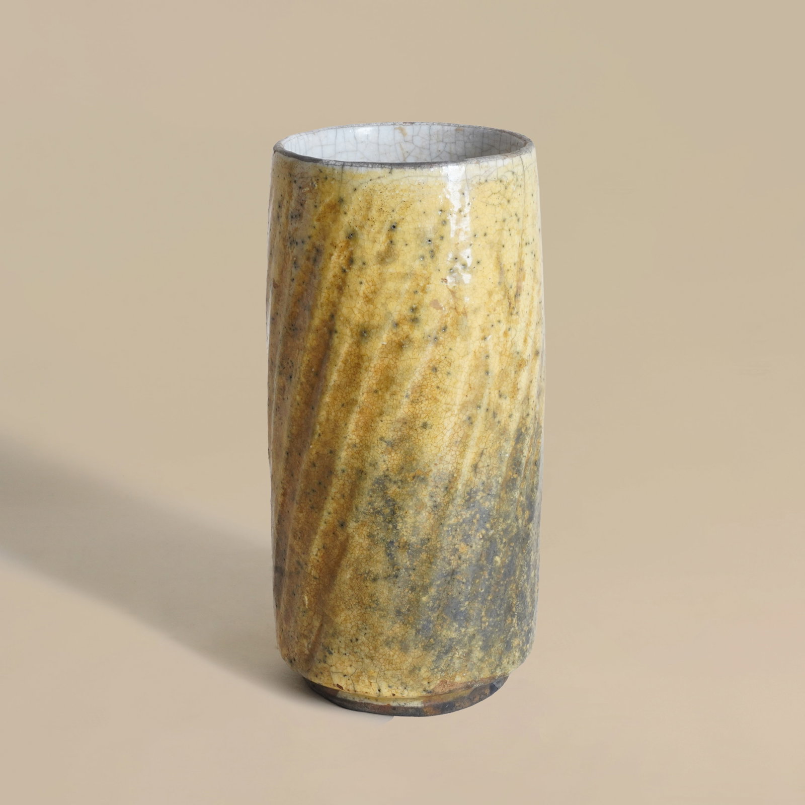 Inger Rokkjaer (Danish 1934-2008) Ochre yellow diagonally-fluted cylinder vase: Circa 2000 Raku fired earthenware Impressed 'IR' seal and Galerie Besson applied label 21cm high Provenance: Private collection Galerie Besson label
