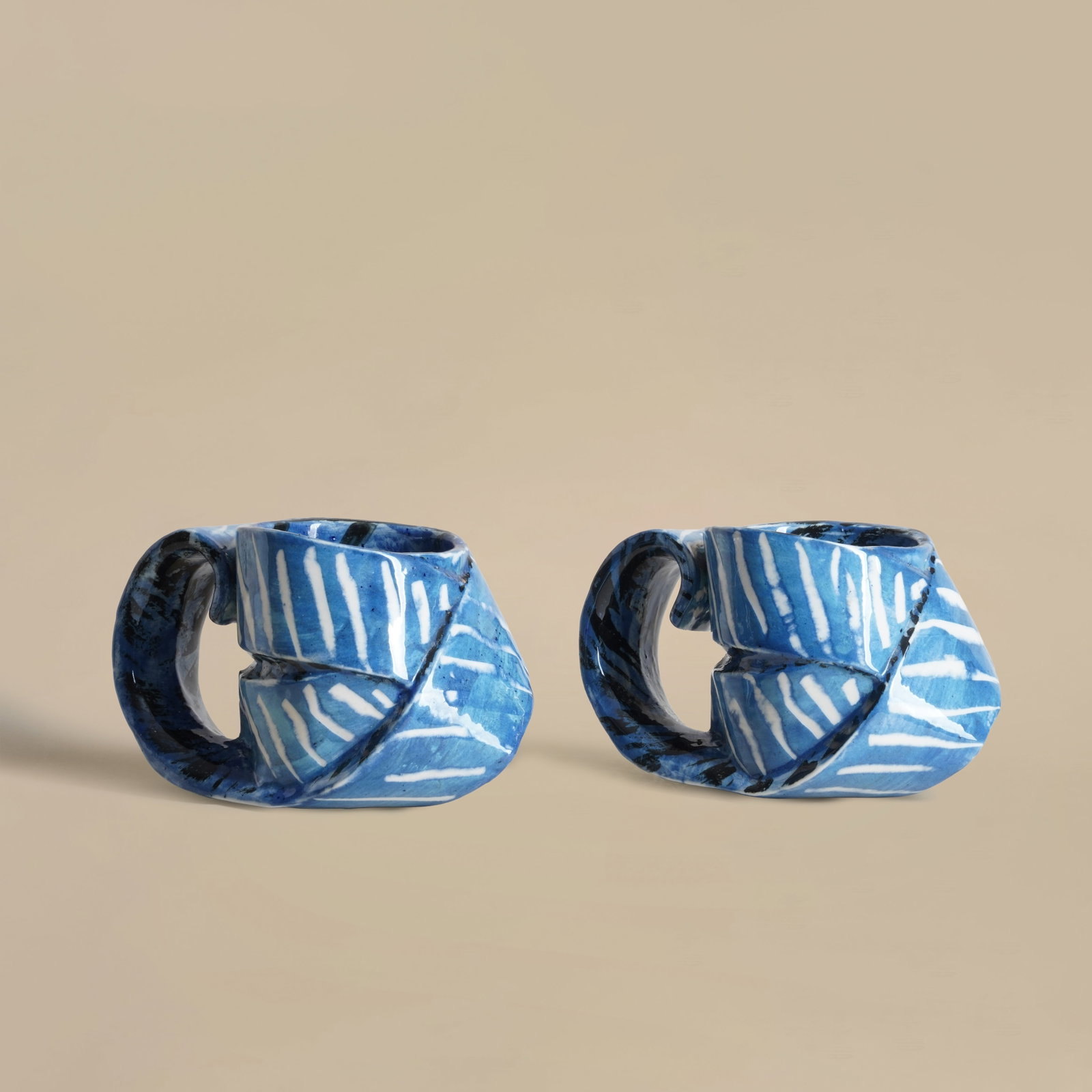 Carol McNicoll (British 1943-2025) Two mugs in blue with white and black linear decoration (1 of 4)