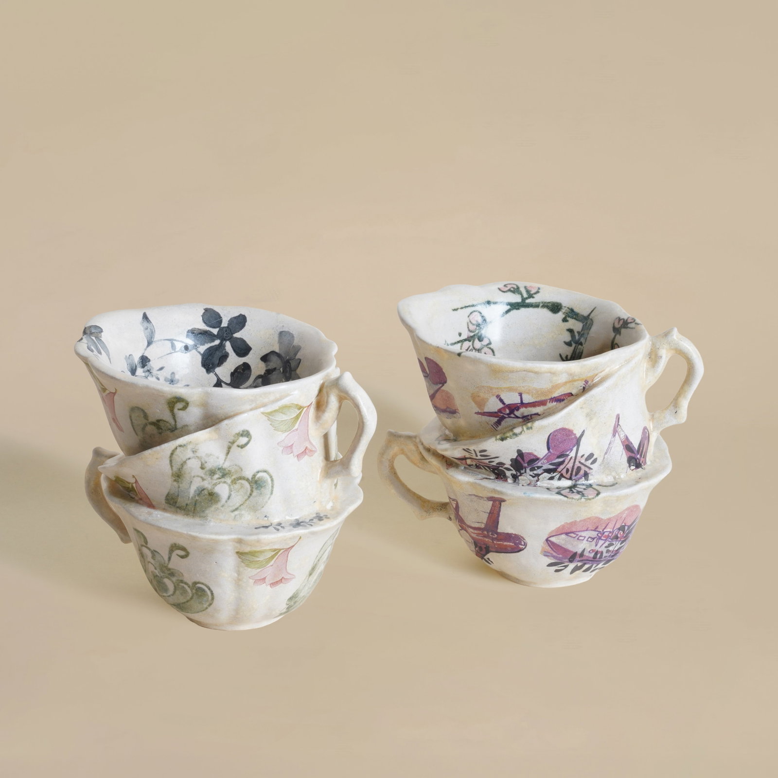 Carol McNicoll (British 1943-2025) Two sculptures of stacking cups form: Glazed earthenware with transfer printed designs Each with painted signature to underside 9.5cm high