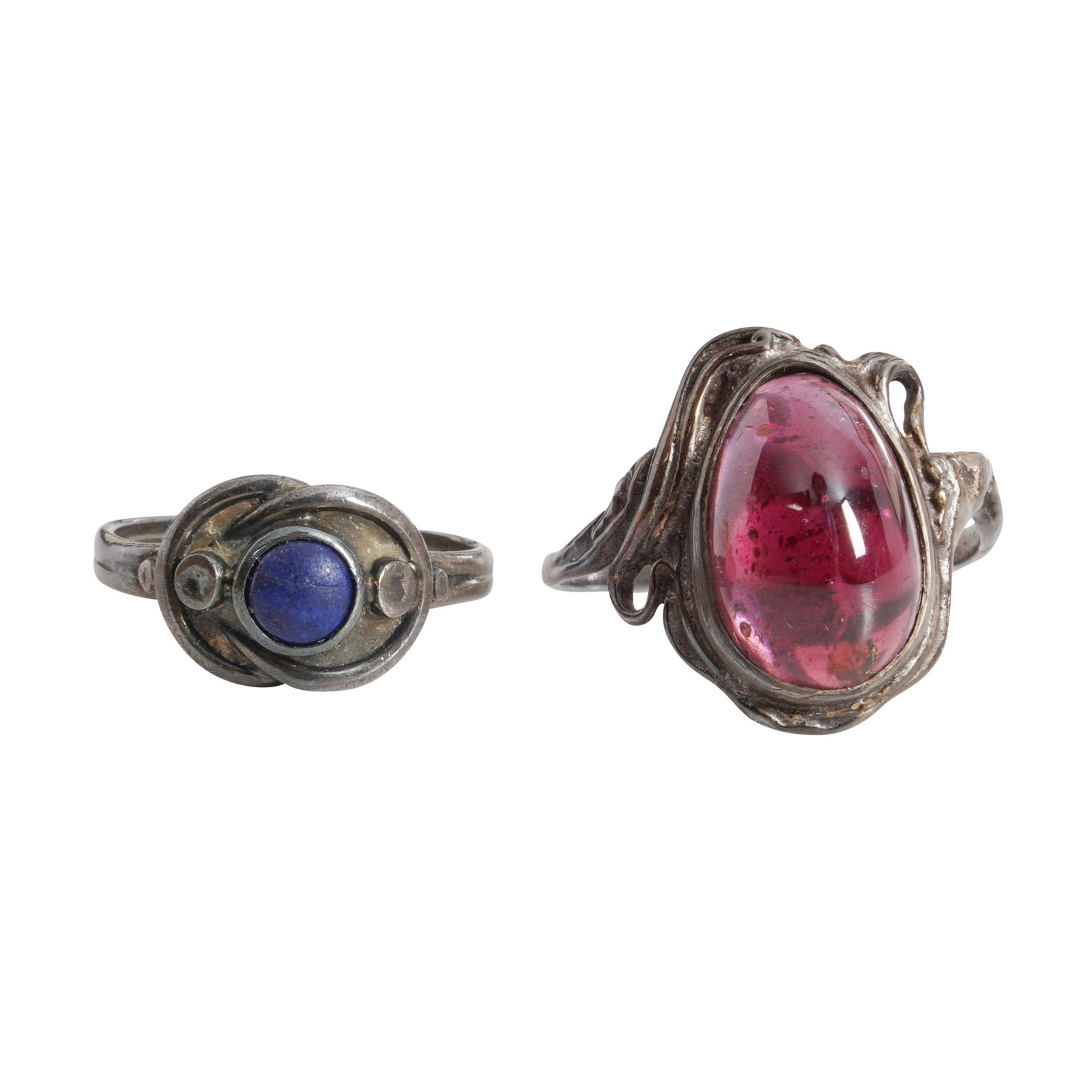 Georg Jensen (Danish) and one other Two Arts and Crafts rings: To include a Georg Jensen white metal ring with blue stone, stamped 'DENMARK', 'GJ', '925', '5', and one white metal ring with pink stone, no marks found (2)