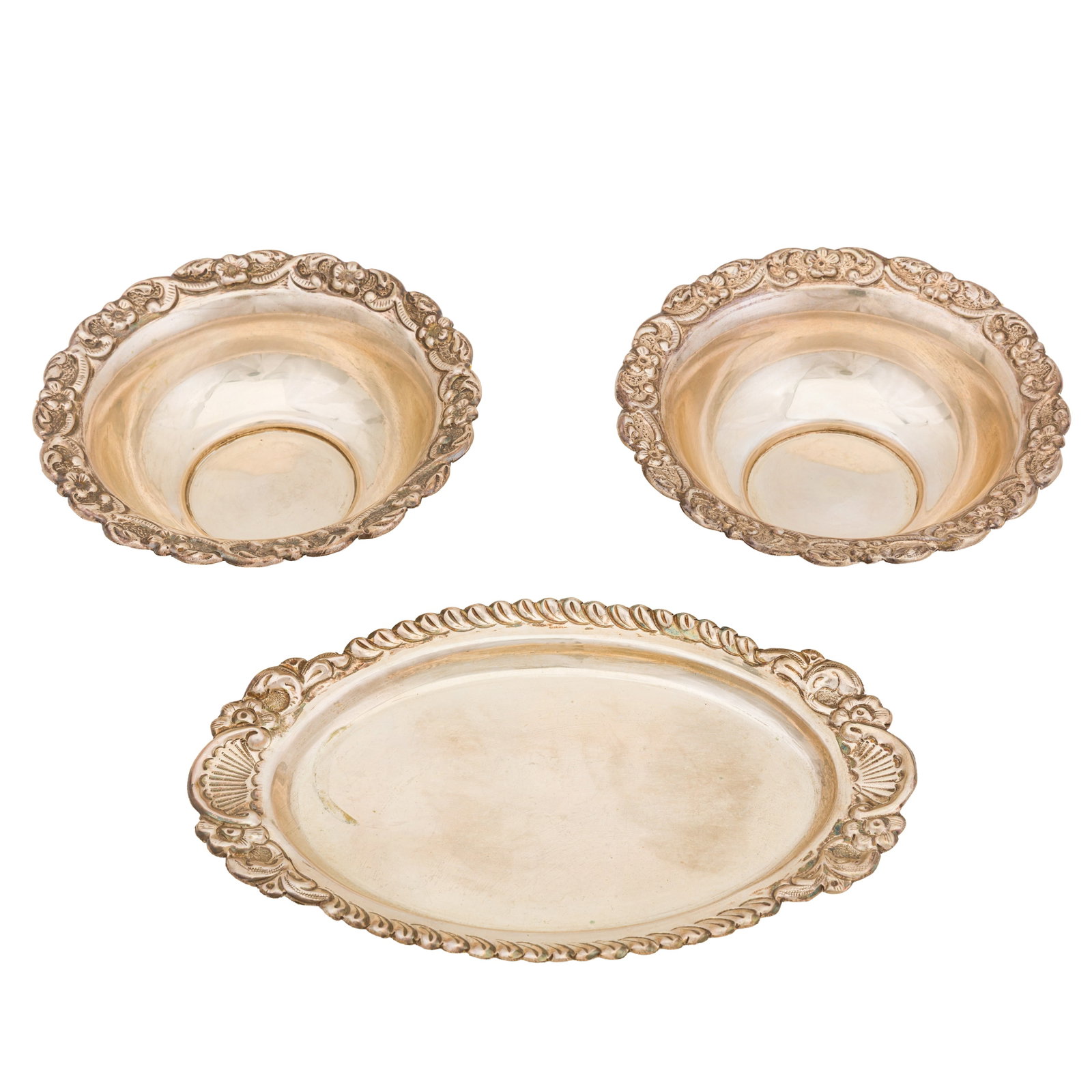 A pair of mid 20th century silver bowls, possibly Turkish: A pair of mid 20th century silver bowls, possibly Turkish Of round form. The rim with embossed flower and scrolling decoration. Together with a similar oval platter. Stamped Silver. Diameter - 13 cm