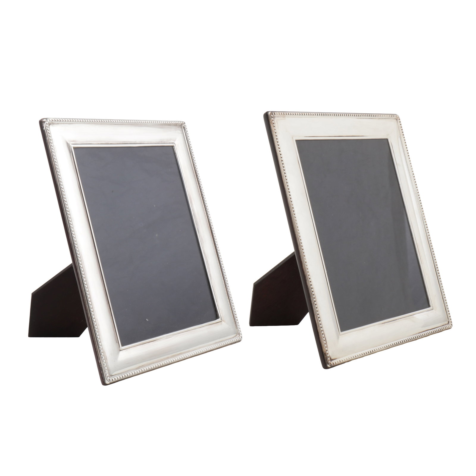 Sheffield 2002 by Carr's A pair of Elizabeth II sterling silver frames: Sheffield 2002 by Carr's A pair of Elizabeth II sterling silver frames Of rectangular form with beaded edge. Wooden back and easel. Fully marked. Height - 25.6 cm / 10.07 inches