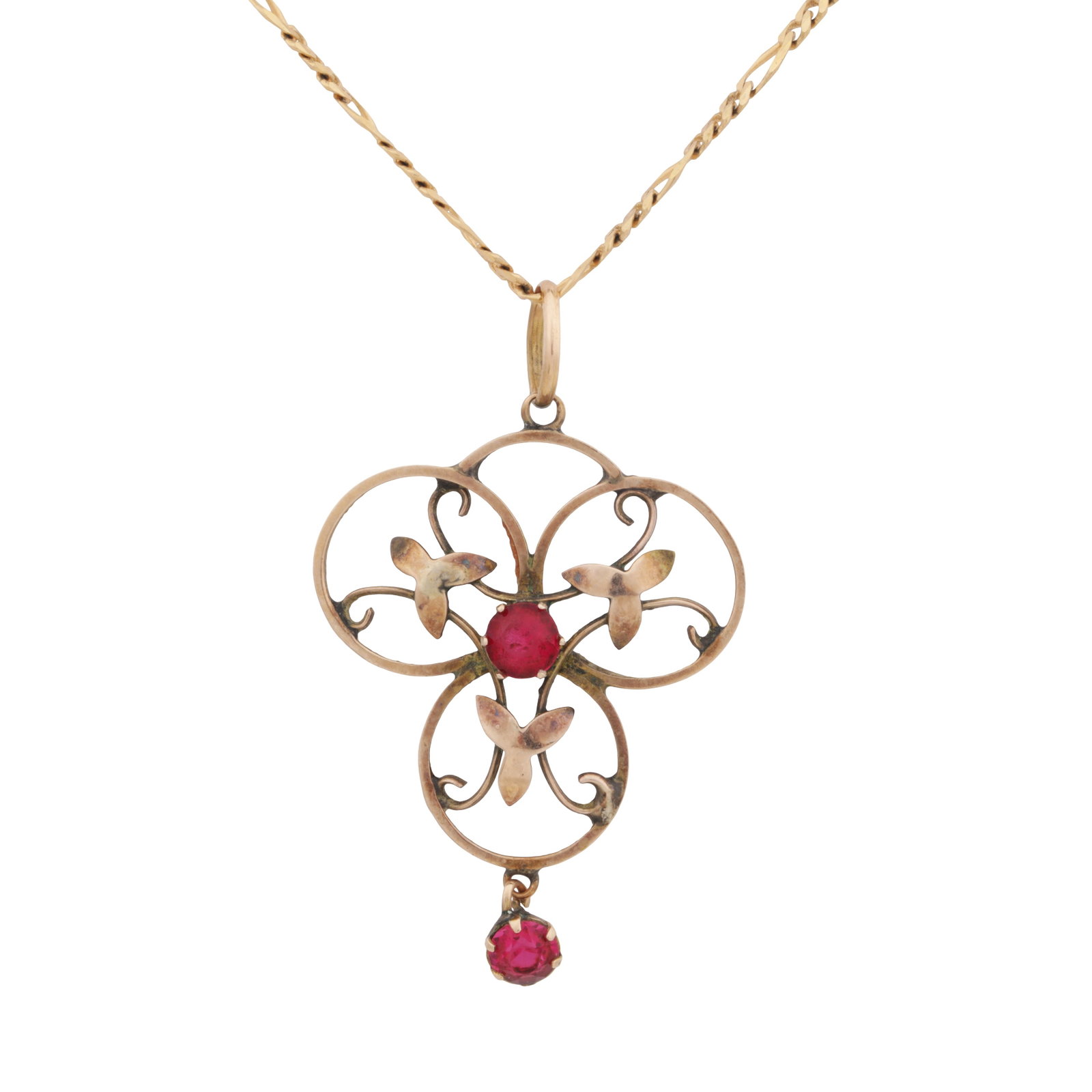 A paste pendant necklace Yellow metal: A paste pendant necklace Yellow metal Pendant of openwork foliate pattern, set with circular-cut red paste, stamped '9C' suspended from a figaro chain with bolt clasp fitting, stamped 9K, length;