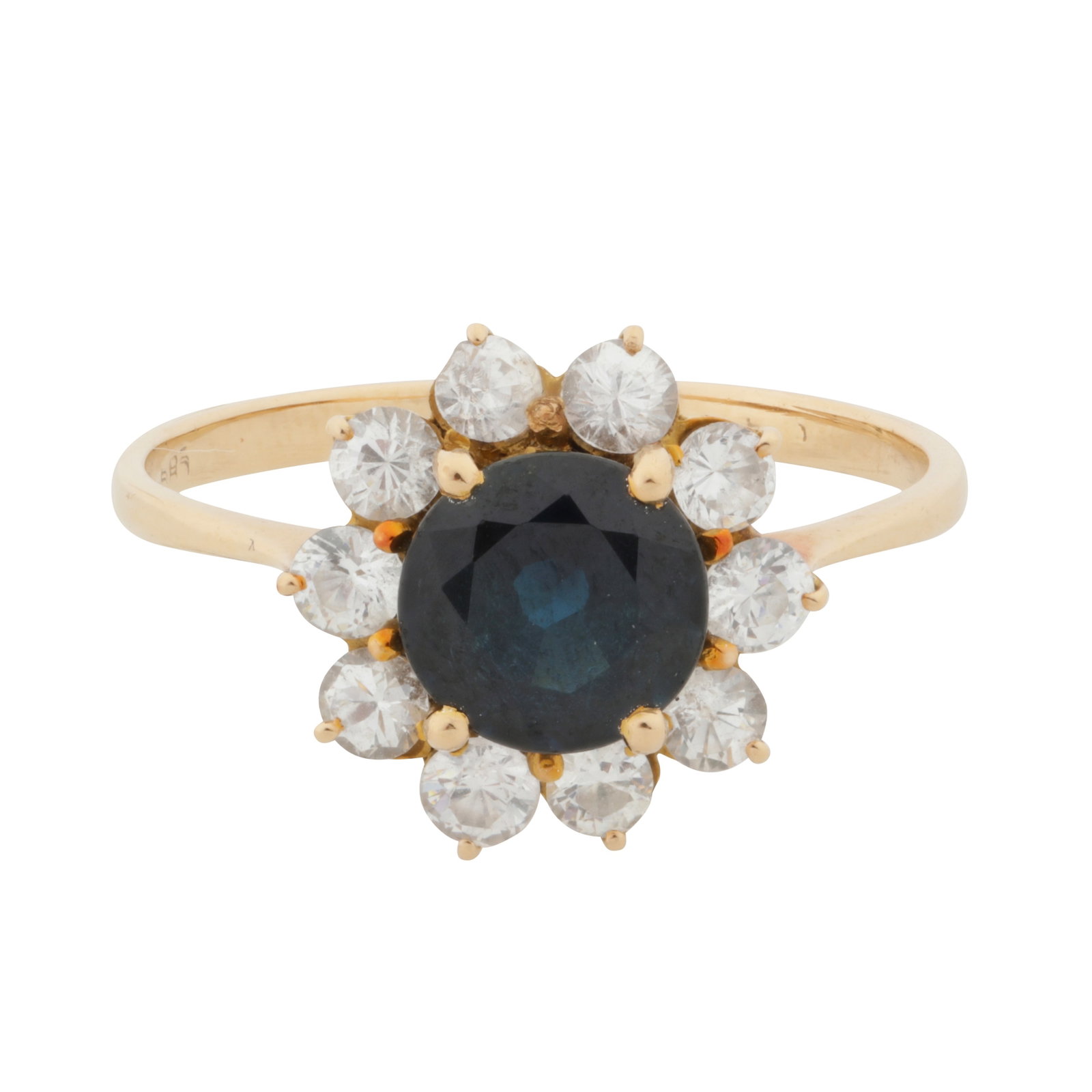 A sapphire and white paste halo ring Yellow metal: A sapphire and white paste halo ring Yellow metal Claw-set with circular-cut sapphire centre, surrounded by circular-cut diamond imitations, to pointed shoulders, stamped 585, ring size P