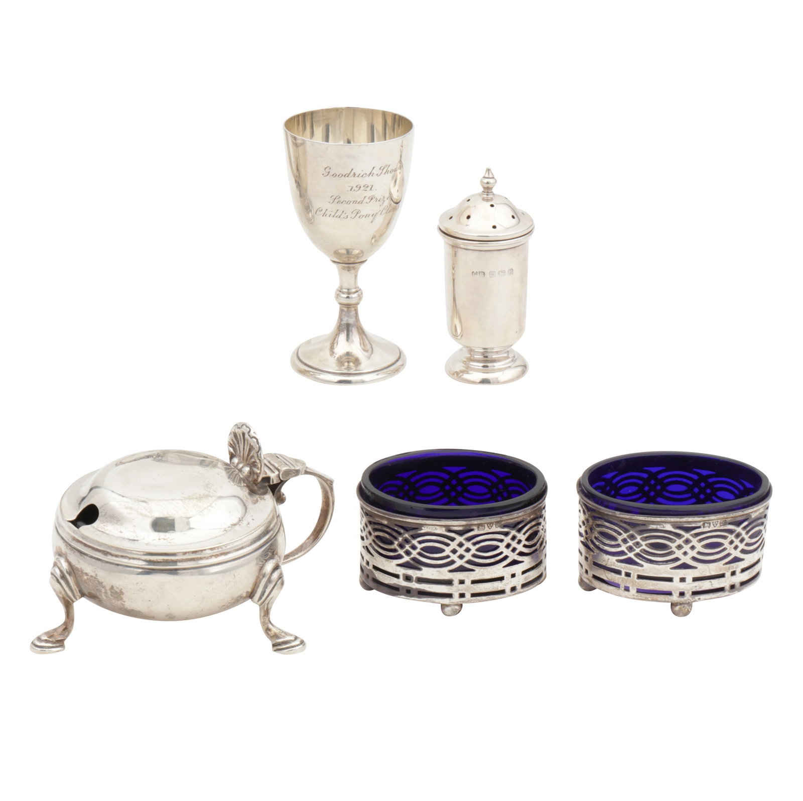A mixed group of George V sterling silver: A mixed group of George V sterling silver Comprising small presentation cup, mustard pot, a pepper, and a pair of salts, one liner stuck. (5) Weighable silver – 168 grams / 5.4 ozt