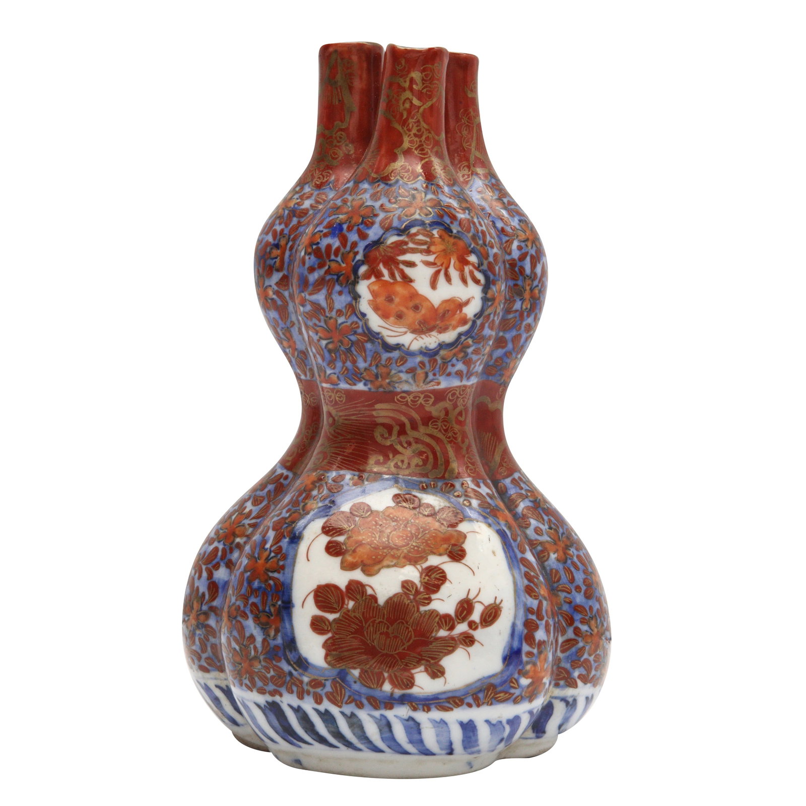 A Japanese Imari conjoined 'double-gourd' vase, Meiji period, 19th century: Formed as a trio of conjoined double-gourds, painted with panels enclosing blossoms reserved against an underglaze-blue ground dotted with foliate motifs, the base unglazed Size:(17.5cm high) Qty: (1)