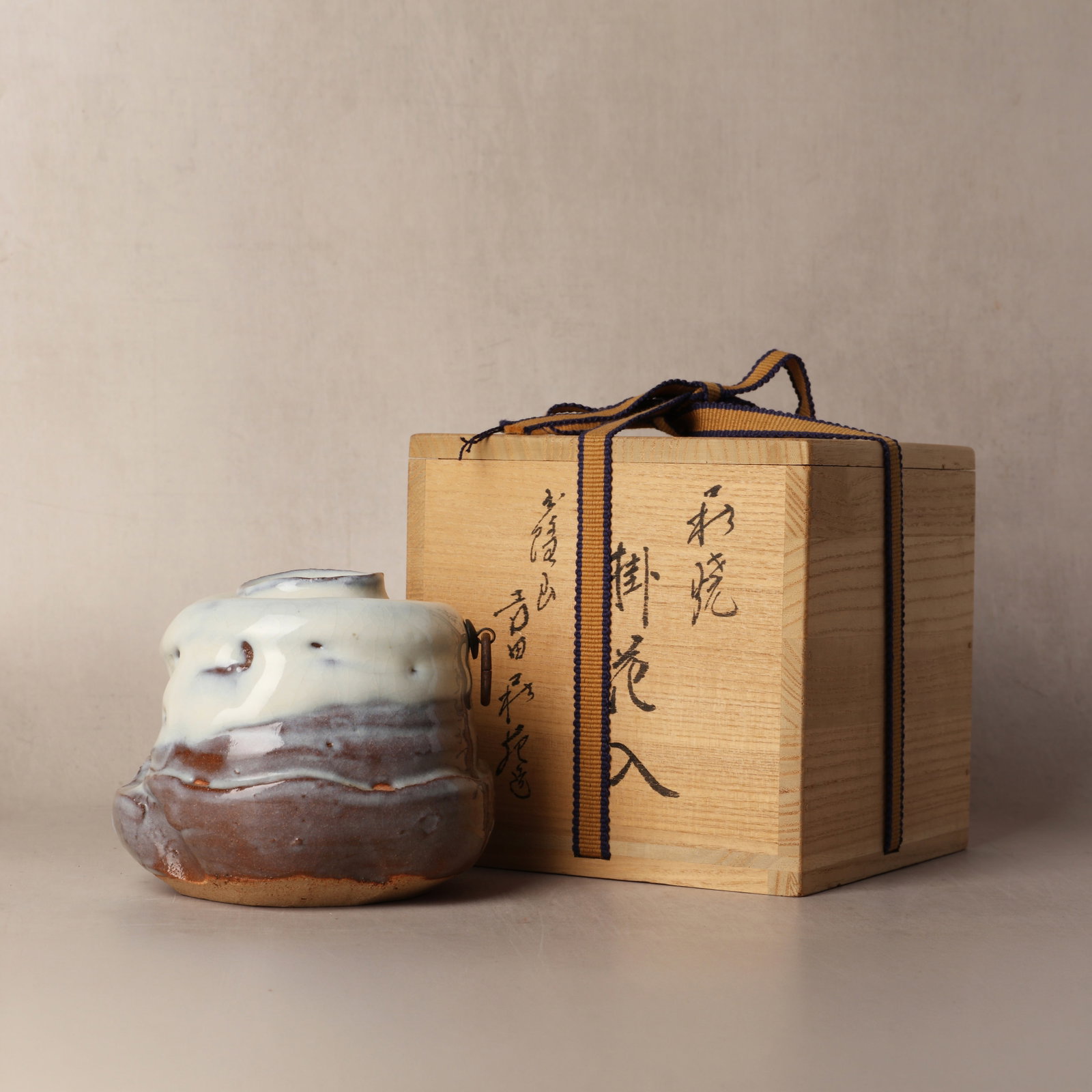Yoshida Shuen (Japanese, 1940?1987): The Hagi ware kakehanaire ikebana hanging flower vase, designed for the alcove of a tea room with an iron ring set into the shoulder of the vase for attachment to the wall, the body sculpted by hand w