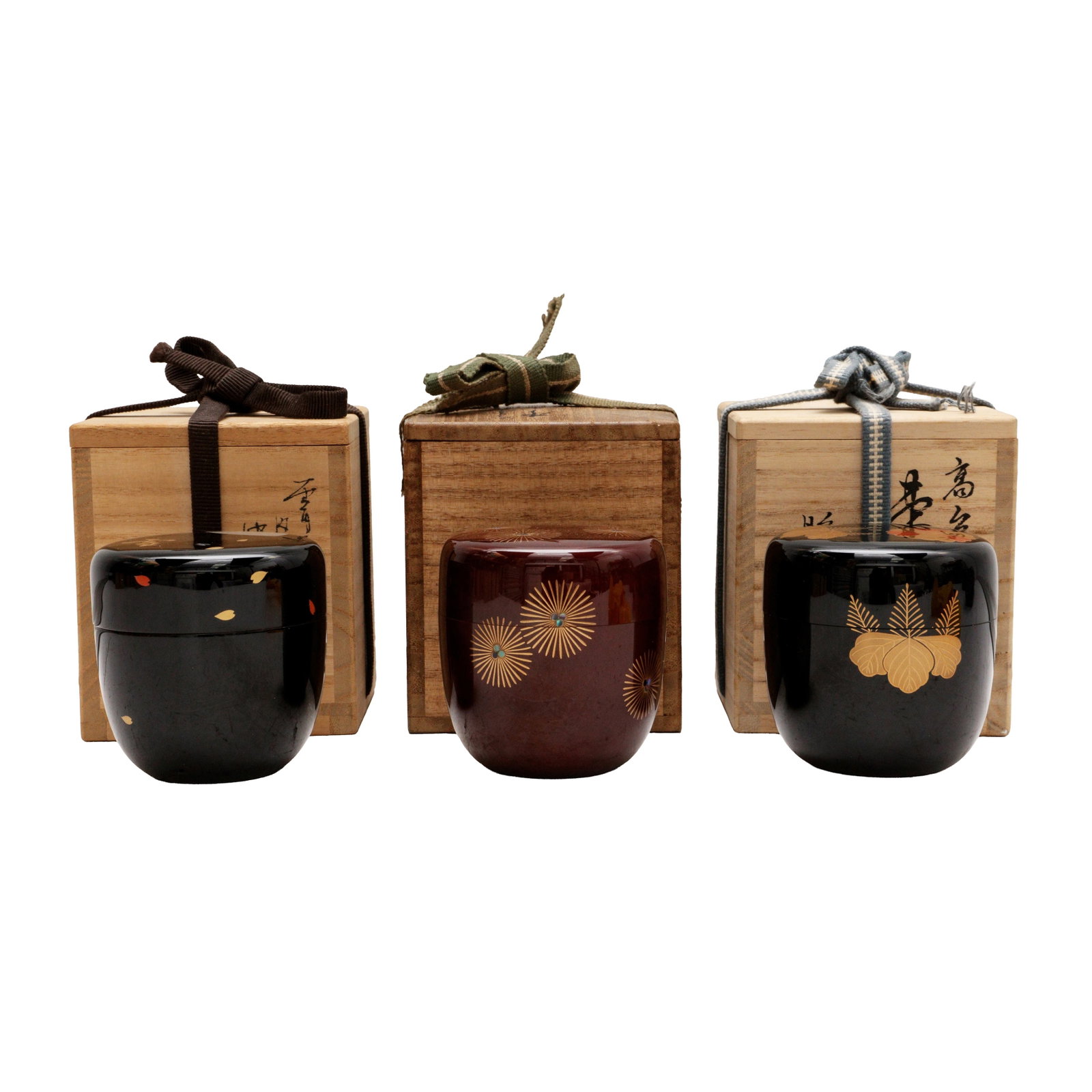 A group of three Japanese lacquer and maki-e natsume tea caddies, 20th century: Comprising three lacquer and maki-e natsume tea caddies together with tomobako wood boxes and covers, inscribed and sealed by the artists Size:(various sizes) Qty: (3) Provenance: Private collection, 