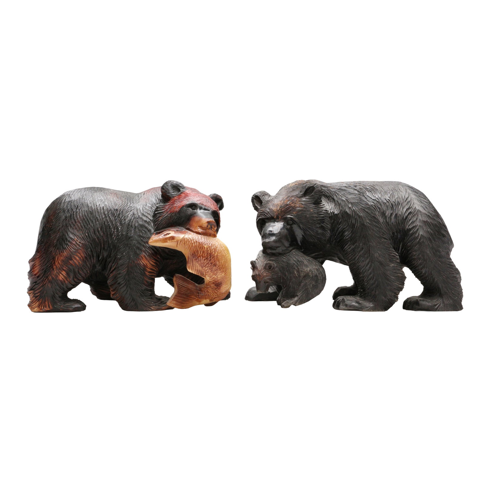 Two Japanese Ainu wood 'Kibori Kuma' bear sculpture, Hokkaido, 20th century: Comprising two robustly carved wood figures in the form of a large bears both carrying a salmon in the mouth Size:(21.8cm highest) Qty: (2) Provenance: Private collection, bought in Japan between 1992