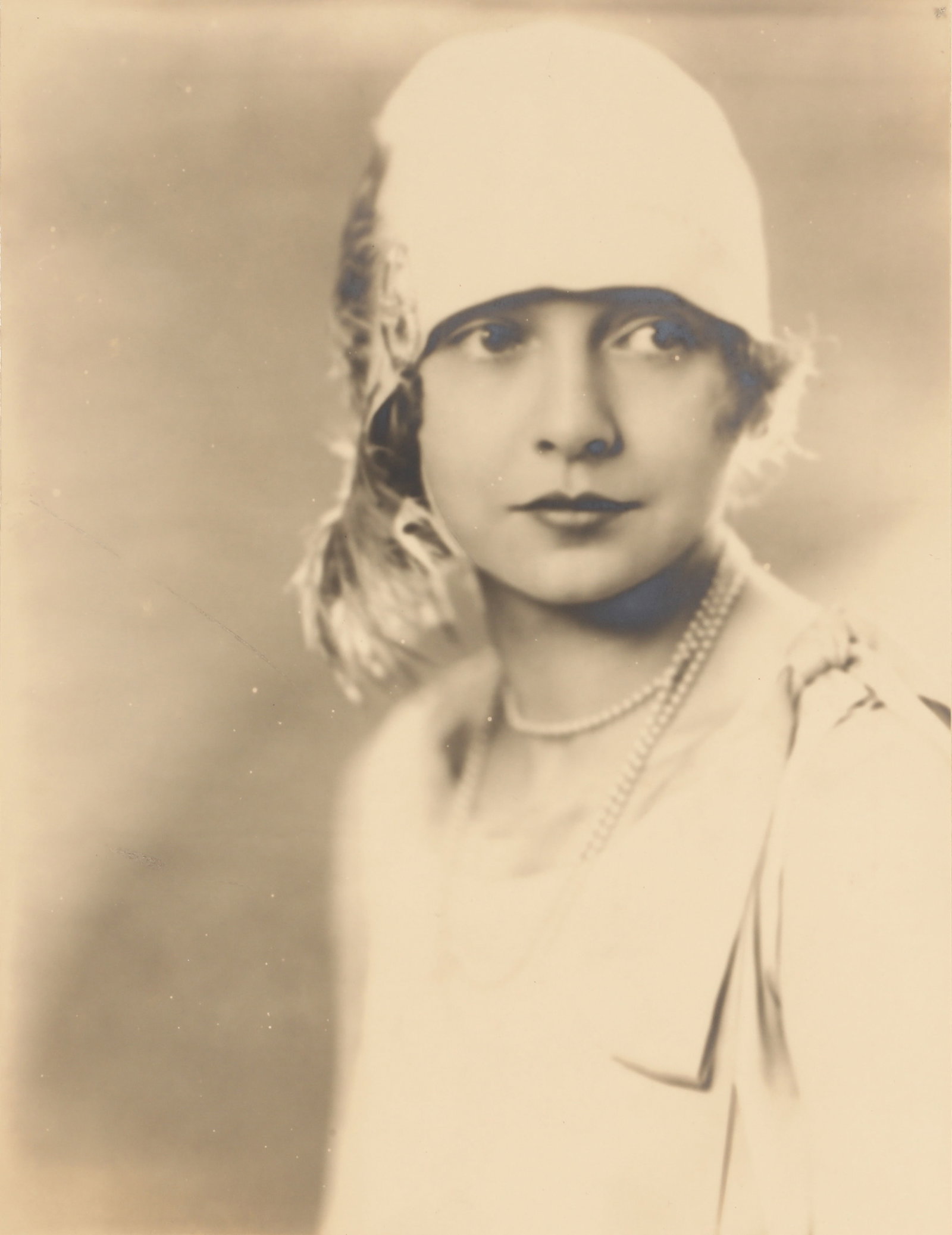 Peter North (active London, 1930s-1950s) Studio Portrait of Louise Brown, c.1930: Vintage bromide silver print, flush-mounted to period card, image size 29.6 x 22.7cm, card size 44 x 31.7, signed by the photographer in pencil lower margin recto, housed in a card envelope bearing th