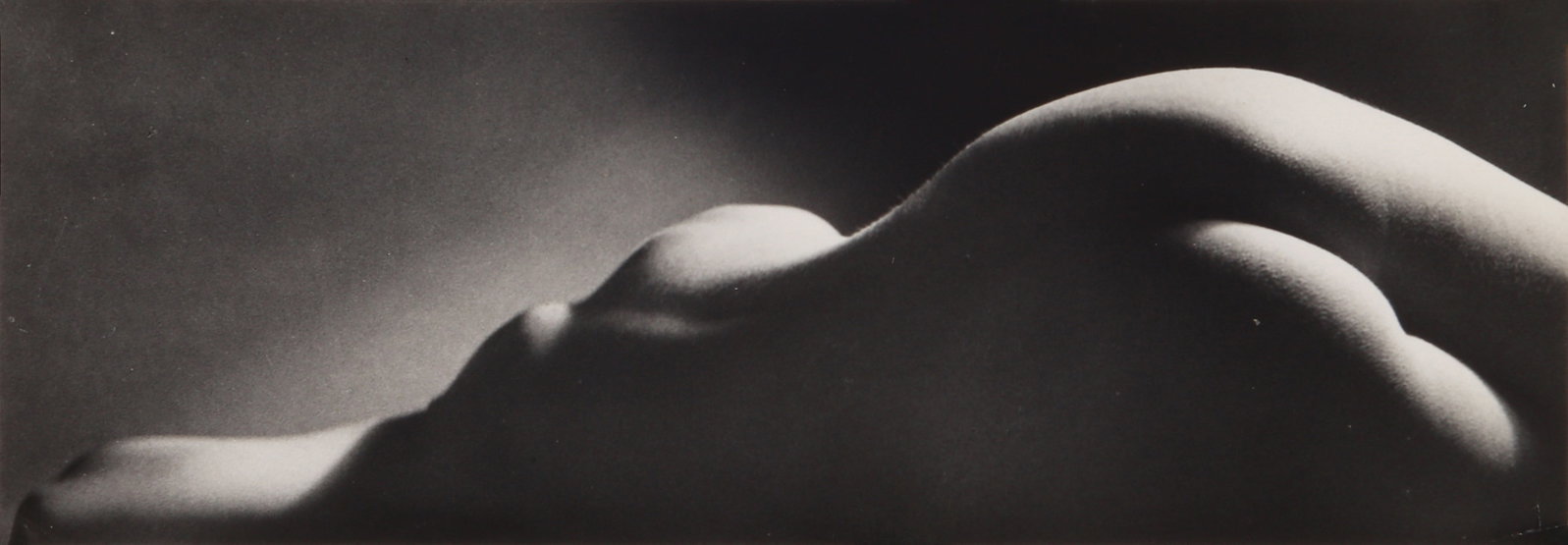 Ruth Bernhard (1905-2006) Sand Dune, 1967: Vintage silver gelatin print, backed with linen, image/sheet size 8.3 x 23.8cm, with Bernhard's Clay Street San Francisco credit stamp visible through the linen, and one further stamp atop the linen. 