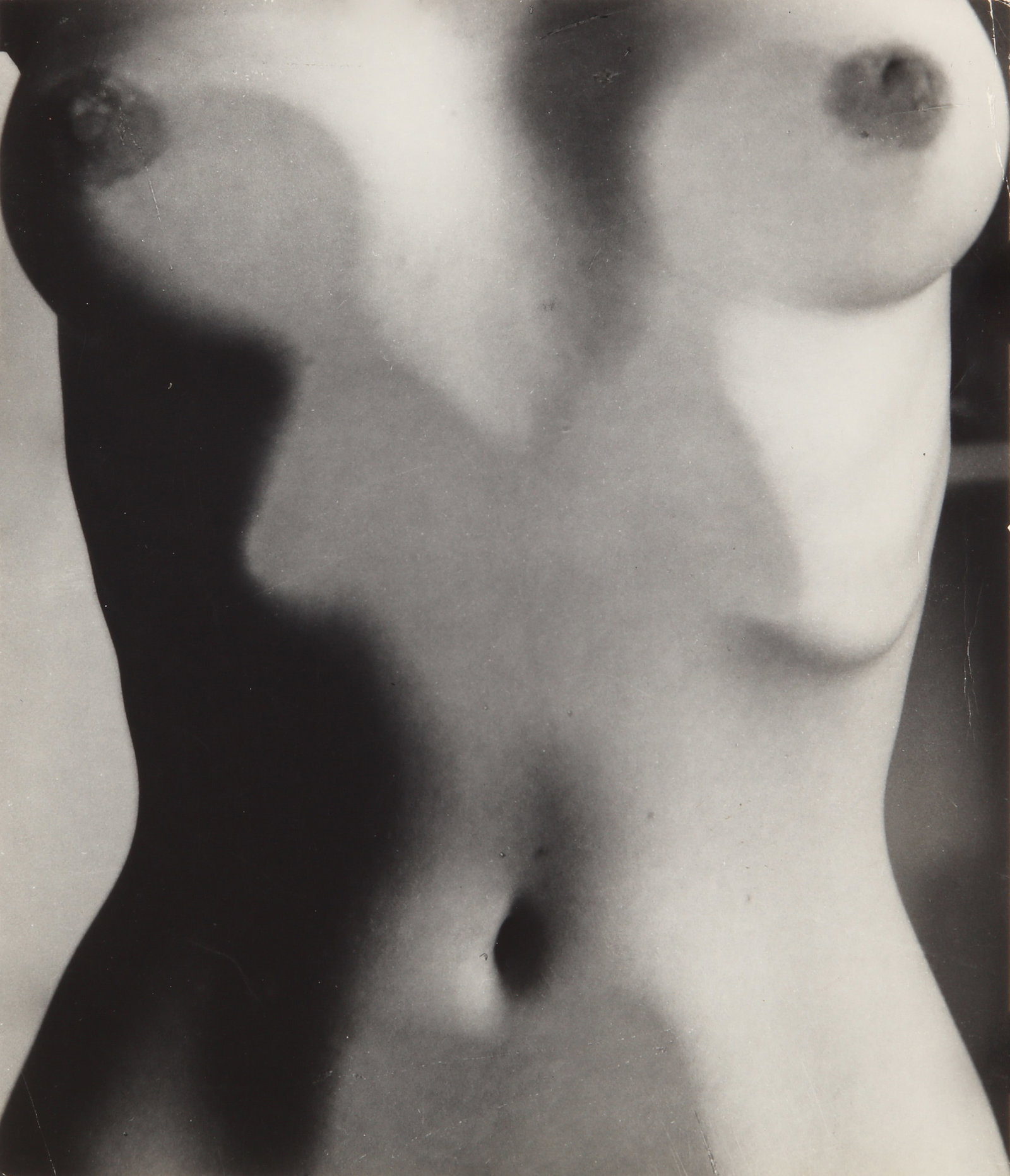 Ruth Bernhard (1905-2006) Abstract Torso Studies, c.1947: A pair of early silver gelatin proof prints, image/sheet sizes 22 x 19cm and 24 x 17.5cm, one signed by the photographer in pencil with various stamps and annotations referencing publication, each wit