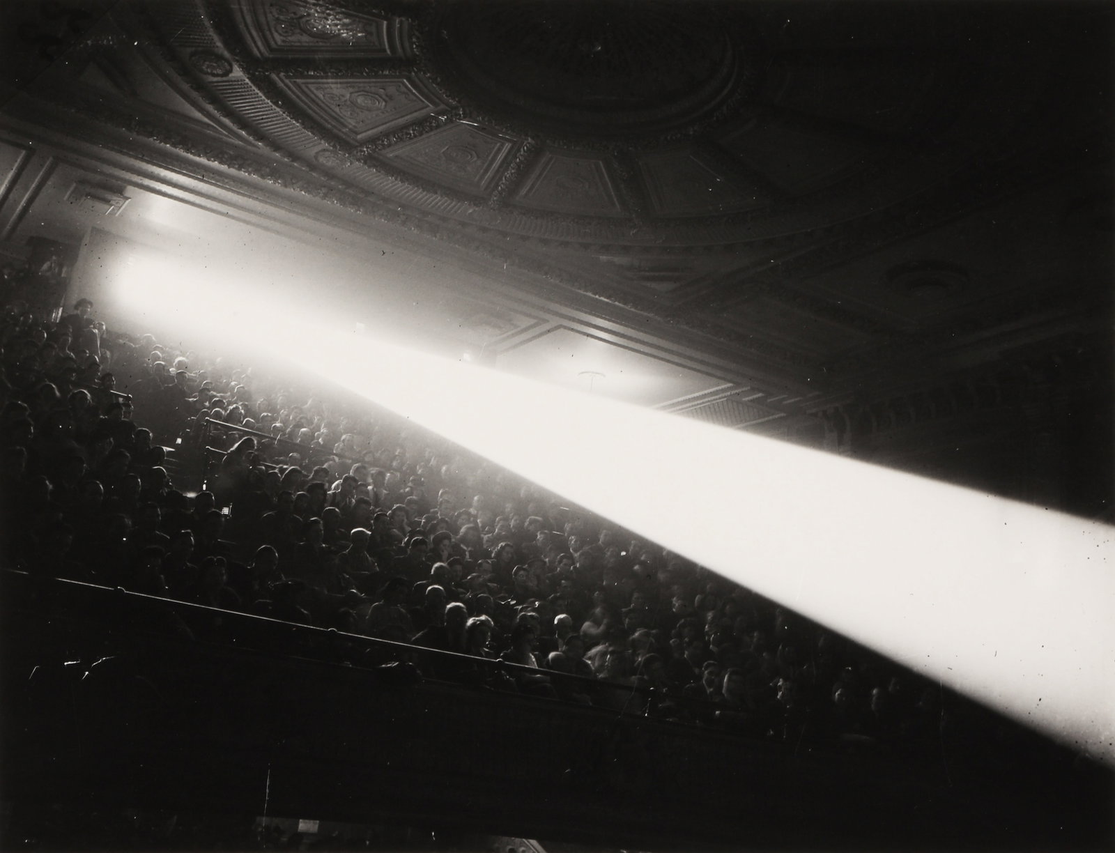 Weegee [Arthur Fellig] (1899-1968) Projector Beam, Loews Commodore Theatre, c.1945 (1 of 3)