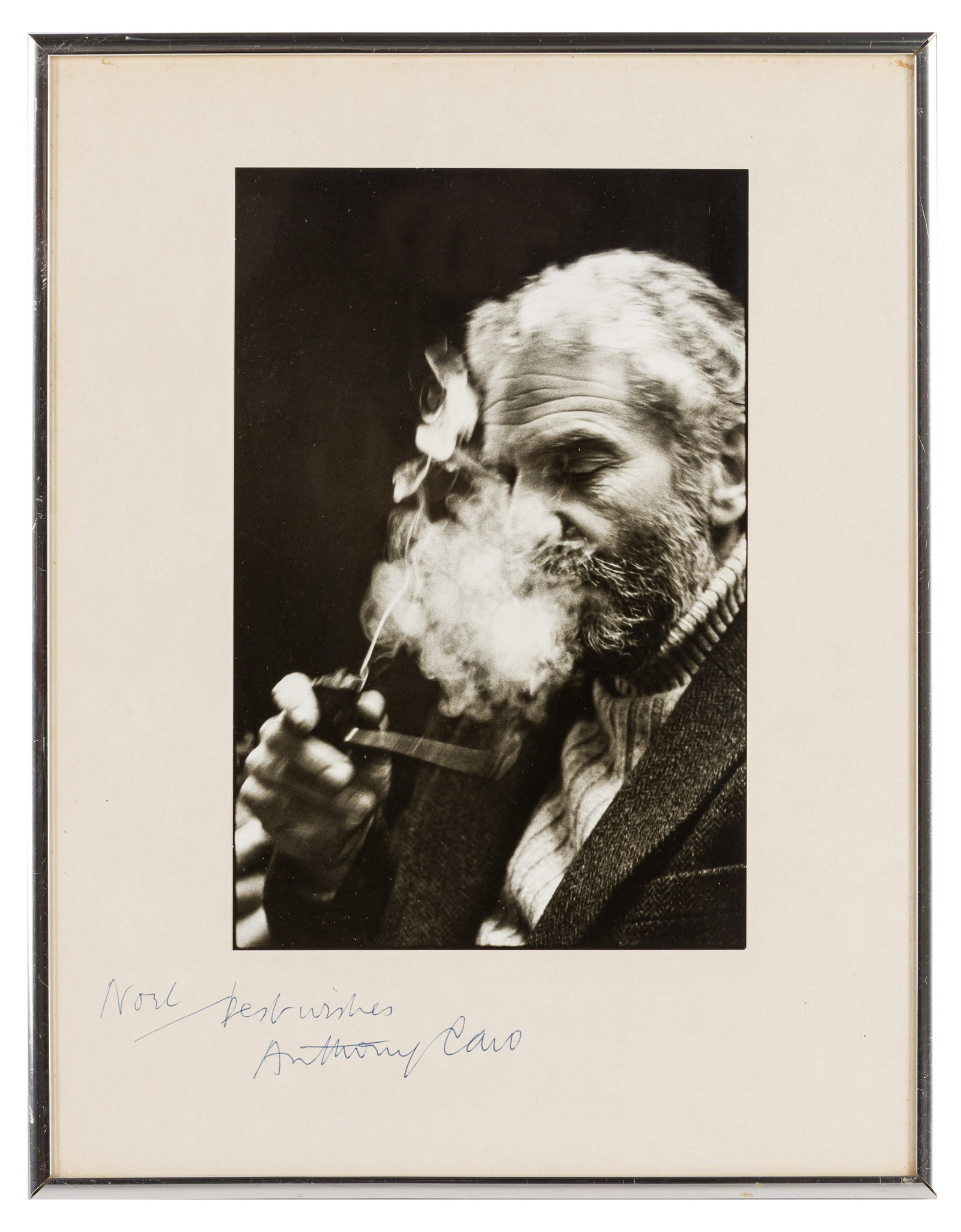 Noel Chanan (1939-2026) Anthony Caro, c.1974: Vintage silver gelatin print, flush-mounted to card, image size 24 x 16cm, card size 34.5 x 27cm, signed and inscribed in ballpoint ink "Noel, best wishes, Anthony Caro" lower margin recto, with the p