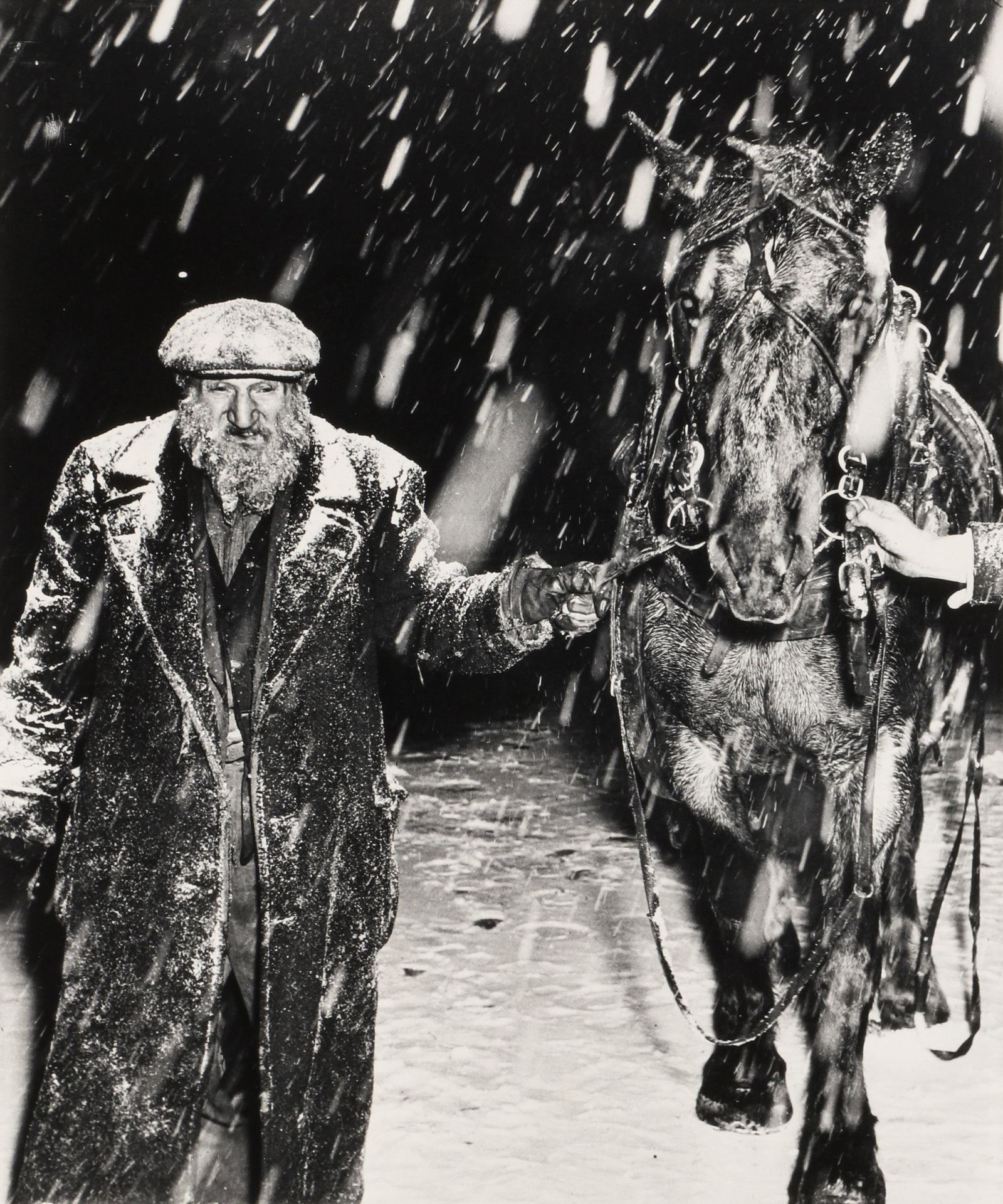 Weegee [Arthur Fellig] (1899-1968) Vegetable Dealer [With His Horse in the Snow], 1946: Silver gelatin print, printed 1980s by Sid Kaplan, image size 38 x 31.5cm, sheet size 50.5 x 40.7cm, with 'Weegee The Famous' and Kaplan's credit stamps verso. Framed, frame size 59 x 54cm. Qty: (1)