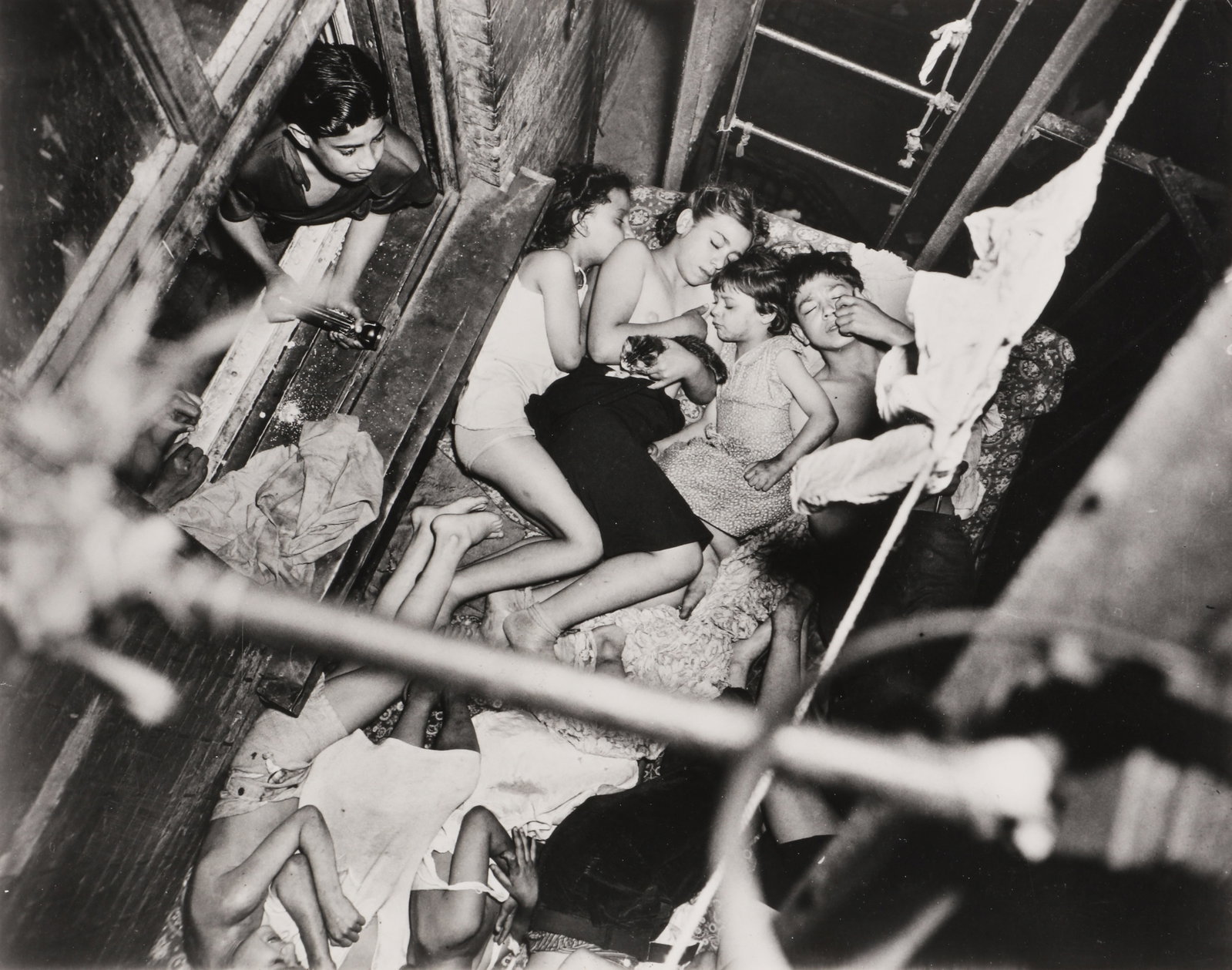 Weegee [Arthur Fellig] (1899-1968) Summer Scenes [Coney Island, 1940 and Heatspell, The Lower East: A pair of silver gelatin prints, printed 1980s by Sid Kaplan, image size 28.5 x 36cm, flush-mounted on board; and 31.7 x41cm, sheet size 41 x48.5cm, with 'Weegee The Famous' and Kaplan's credit stamps