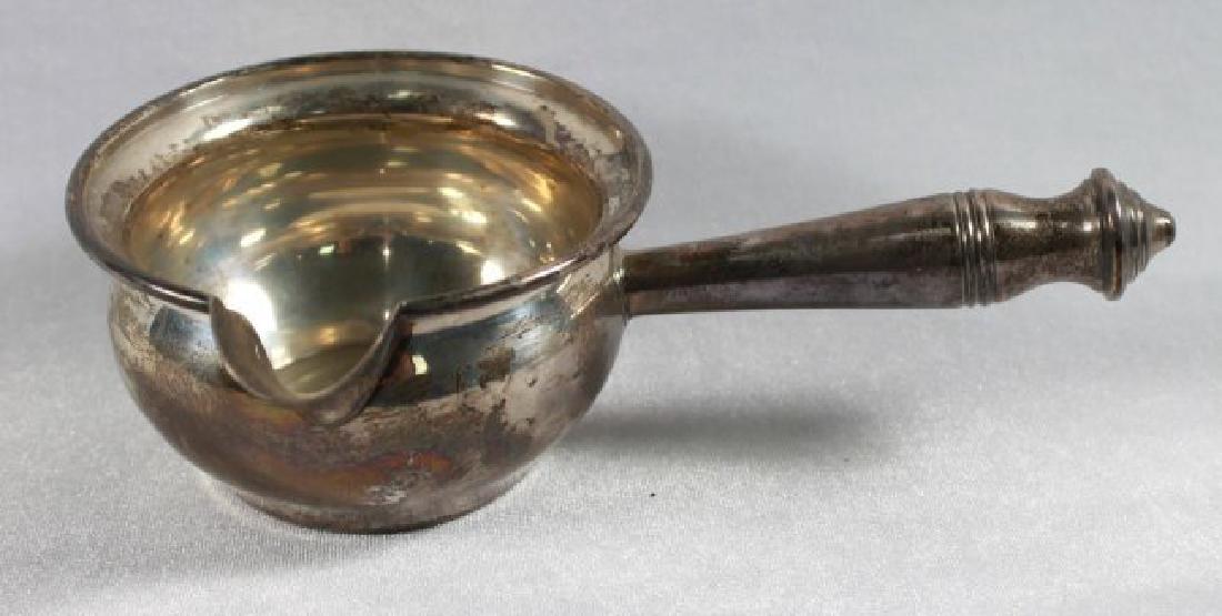 STERLING SILVER CUP WITH HANDLE: STERLING SILVER CUP WITH HANDLE. MEASURES 7" LENGTH. TOTAL WEIGHT IS 68 GRAMS