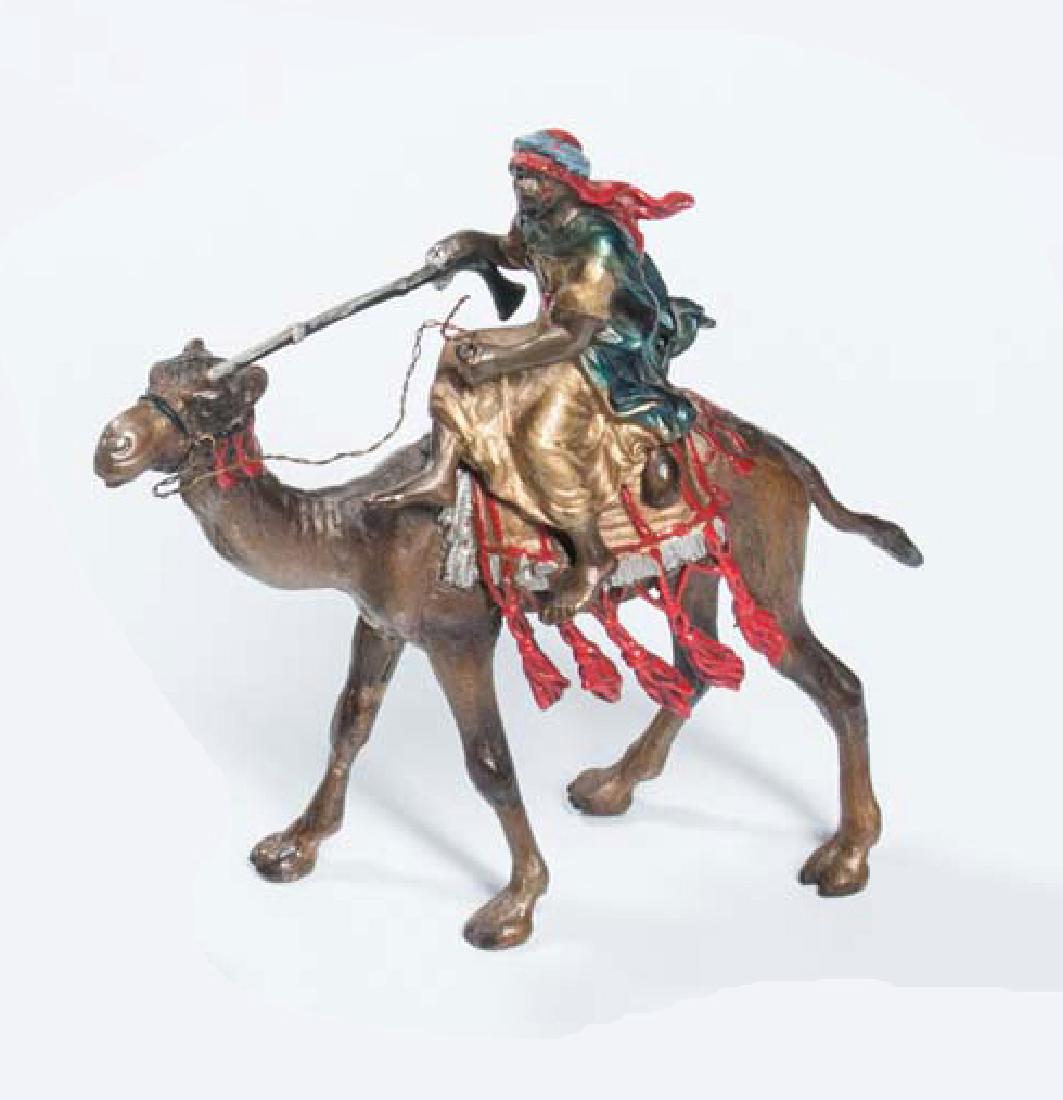 Austrian Cold-painted Bronze Figure, early 20th century: Austrian Cold-painted Bronze Figure, early 20th century, polychrome, of a man in a camel holding a firearm, ht. 5 1/4, impressed vasiform "B" marks;