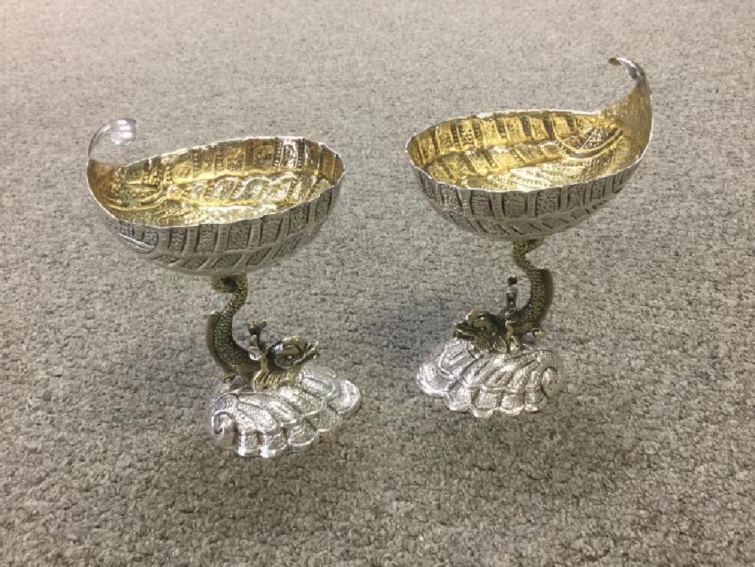 Pair of Sterling Monkey Riding a Dolphin Cups: 7oz each6 3/4" tPair of 1800's Gold washed silver master salts table centerpiece ornaments with large feather like containers. Stems fashioned as stylized dolphins with cherub riders holding horns