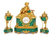 A French Gilt Bronze And Malachite Clock Garniture