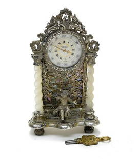 Tiffany & Co Silver Clock: A charming German .800 Silver Clock in the Renaissance Style by Martin Mayer and retailed by Tiffany & Co. Mother of Pearl Columns carved to a sprial twist to each side of a seated cherub, a lustrous