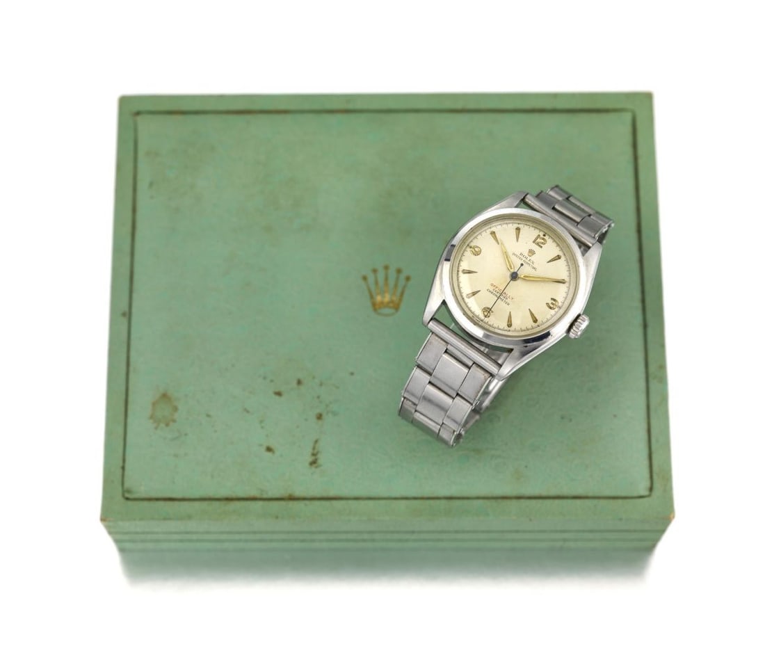 A Rolex Oyster Perpetual Chronometer Wristwatch: 1951/1952 Ref: 6084, semi-bubble back Dial: Circular white dial, signed Rolex / Oyster / Perpetual / Officially (red) / Certified / Chronometer, intaglio cut and gilt Arabic hour markers with luminous