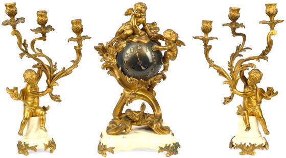 A French Gilt Ormolu Bronze Marble Clock Set Garniture: A French Gilt Ormolu Bronze Marble Clock Set GarnitureThis charming Circa Late 19th-century French Louis XVI Style Clock set is a testament to eleganceBeautifully made in ormolu (finely gilded