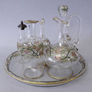 BACCARAT AND ENAMELLED GLASS 6 PCS. CRUETT SET: BACCARAT AND ENAMELLED GLASS 6 PCS. CRUETT SET. THE TRAY MEASURES 9 1/4" DIAMETER AND THE BIGGEST BOTTLE MEASURES H: 6 3/4"