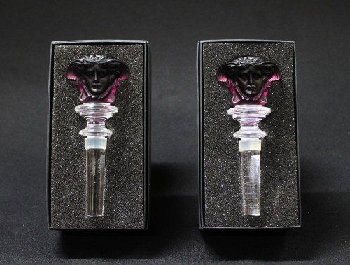 A Pair of Versace Figural Top Bottle Stoppers: A Pair of Versace Figural Top Bottle Stoppers with original boxes. They measure H:5 1/4" W:2"