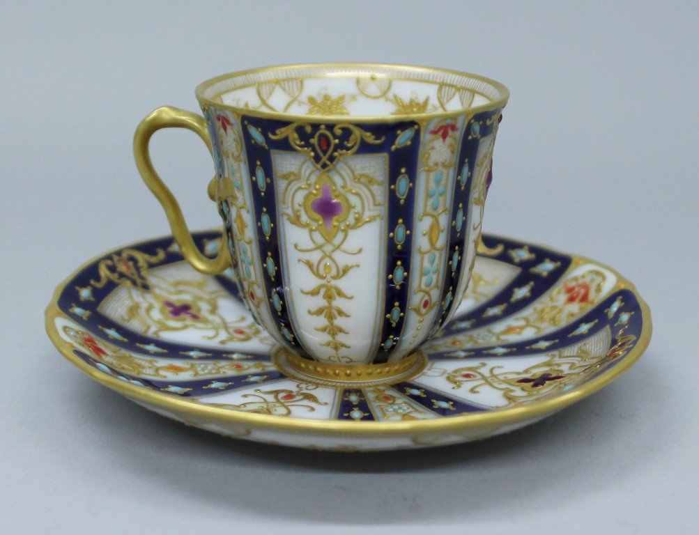 BERLIN KPM JEWELLED CUP AND SAUCER 19TH C.: BERLIN KPM JEWELLED CUP AND SAUCER 19TH C. THE CUP MEASURES H: 1 3/4" AND THE SAUCER MEASURES 4" DIAMETER