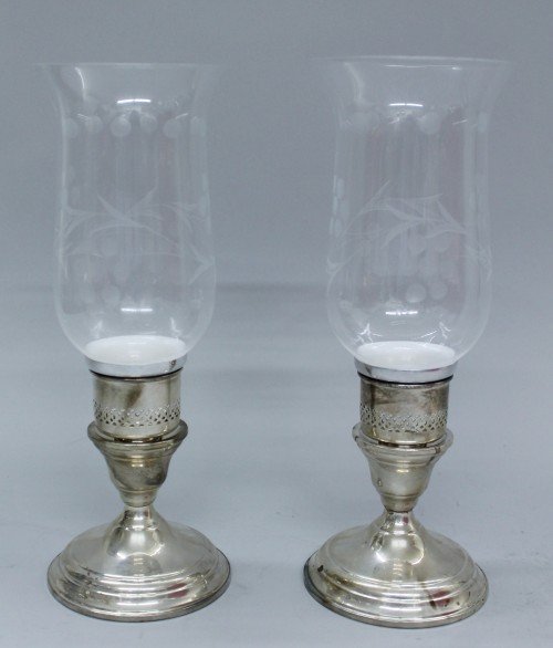 RARE CARTIER STERLING SILVER AND GLASS HURRICANE C: RARE CARTIER STERLING SILVER AND GLASS HURRICANE CANDLE HOLDERS W/ ORIGINAL BOXES. THE HURRICANES MEASURE ABOUT 10" TALL, THE INSERTS MEASURE ABOUT 2" TALL. COMES WITH ORIGINAL RED CARTIER BOXES (2) A