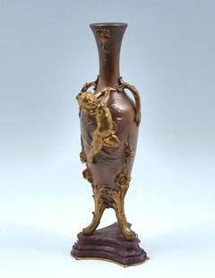 Auguste Moreau Bronze Period Vase: AUGUSTE MOREAU BRONZE PERIOD VASE: Bronze handles vase with Putti, having gilt foliate accents. Mounted in a beveled Brick Red marble base. Incised signature Auguste Moreau. Approx. 14.25" h x 5" w.