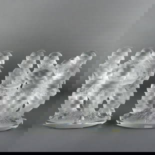 Pair Of Lalique Luxembourg Cherub Groups: Lalique, France. Pair of frosted glass crystal bookends depicting a group of cherubs or putti. Marked "Lalique France" along the base with a Cristal Lalique Paris sticker affixed to the verso of one s