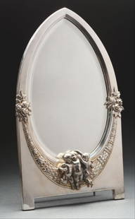 Sterling Silver Plated Table Mirror.: A Wmf Silver Plated Table Mirror, The Pointed Oval Beveled Plate With A Conforming Frame Chased With A Laurel Wreath And Applied With A Group Of Cherubs, The Wood Back With An Adjustable Strut. Height