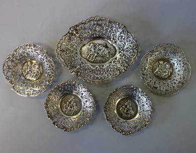 Continental Silver Nut / Candy Dishes: A Group Of Continental Silver Nut / Candy Dishes. Comprised Of An Oval Dish, 5" X 4" And Two Smaller Dishes, 3-1/8" Diameter, Each Decorated With A Central Medallion Depicting Putti / Cherubs At
