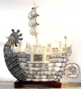 Chinese Carved Bone Phoenix Boat: Chinese carved bone phoenix boat. This stunning sculpture features a large boat with a phoenix masthead. The exterior of the boat is beautifully decorated with incising and pen work. Small ivory