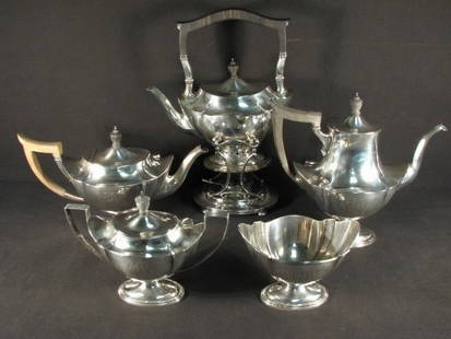 GORHAM STERLING SILVER FIVE PIECE TEA SET: Gorham sterling silver five piece tea set. Includes a 9.75" long teapot with sterling silver stand and heater, an 8.4" wide handled and covered sugar dish, a 10.75" long teapot with wooden handle, an