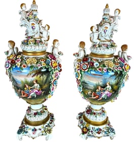 A pair of hand-painted porcelain vases embellished with cherubs