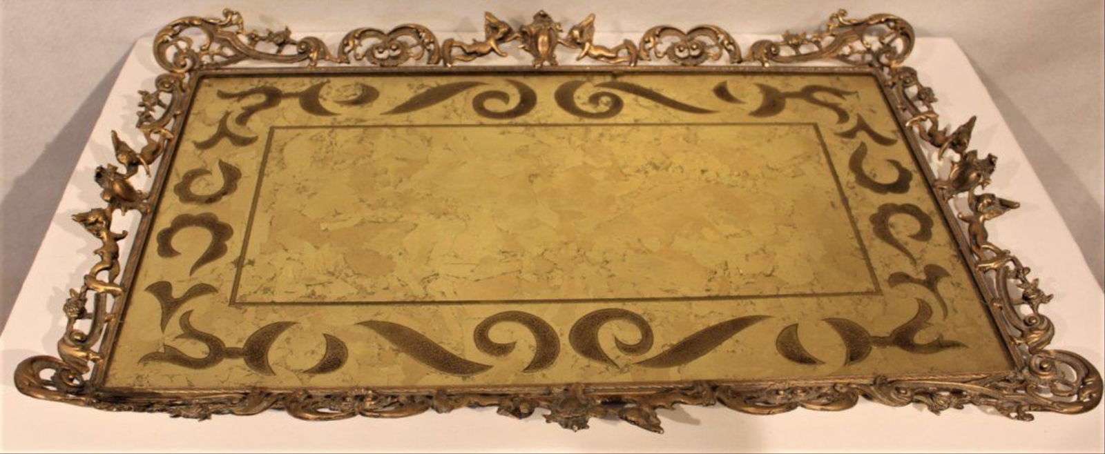 Large Brass French Putti Border, Eglomise Dresser Tray: Large Brass French Putti Border, Eglomise Glass Top Dresser Tray.Size 25.5 In. Length, 16 In. Width, 2 In. Height