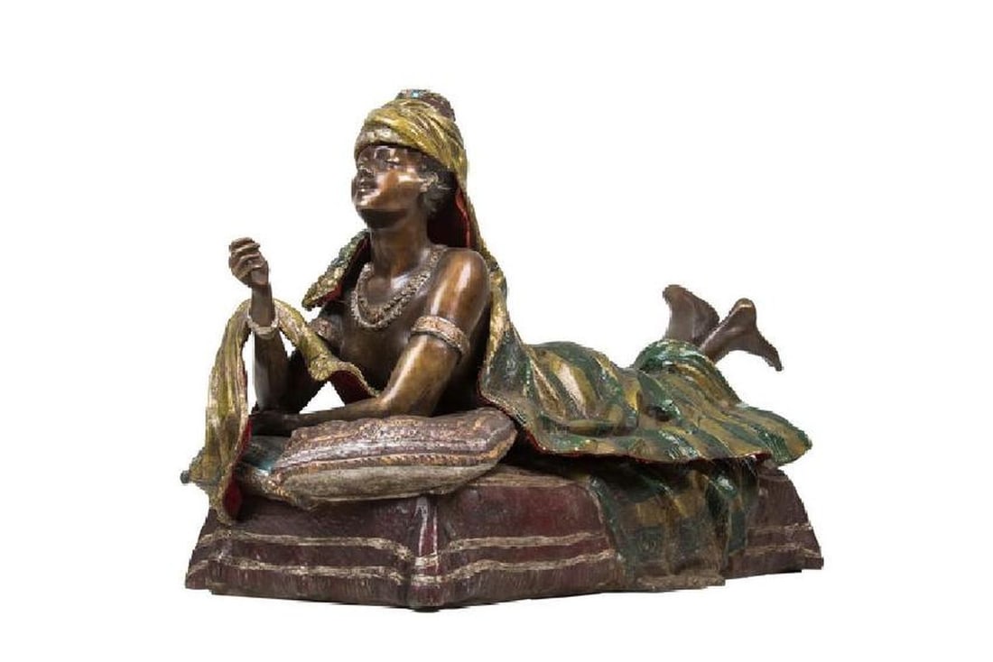 Austrian Style Polychrome Bronze Of A Woman: Austrian Style Polychrome Bronze Of A Woman Depicting An Erotic Woman Lounging Across Pillows Of Various Sizes; With A Removable Wrap, Cloak, And Hat 27 Inches Wide; 11 1/2 Inches Deep; 16 Inches High